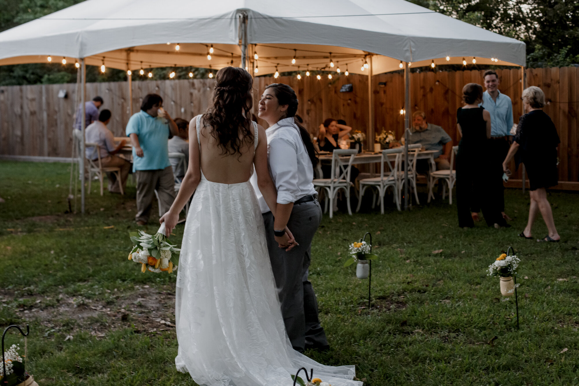Cozy Laid-Back LGBTQ+ Backyard Wedding. After sunset portraits of brides in the evening lights