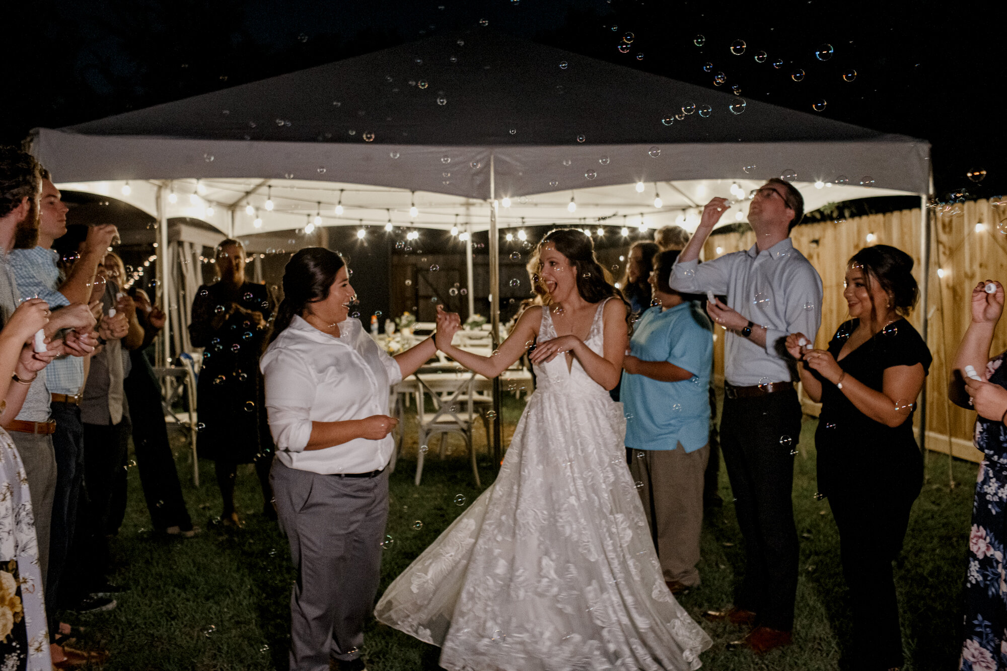 Cozy Laid-Back LGBTQ+ Backyard Wedding. Brides grand exit send off with bubbles