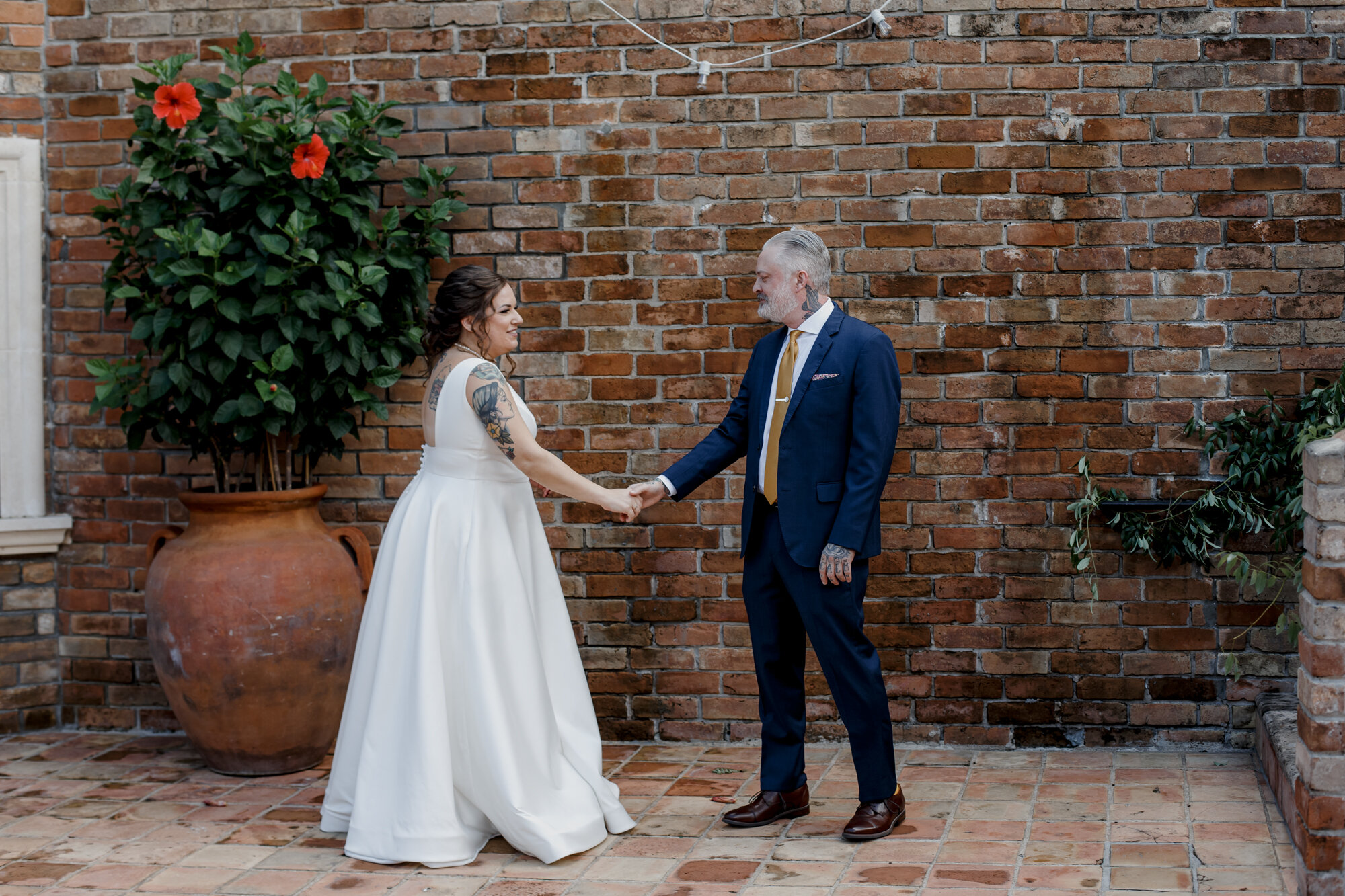 Bride and groom hold hands. Rock Star Wedding at The Gallery