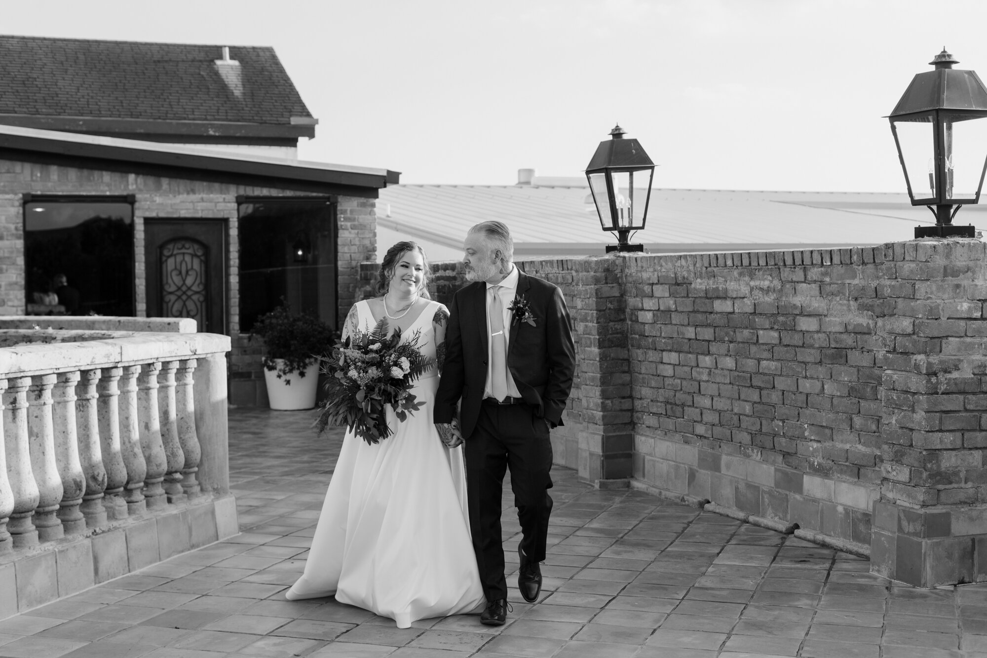 Bride and groom walking on a terrace. Rock Star Wedding at The Gallery