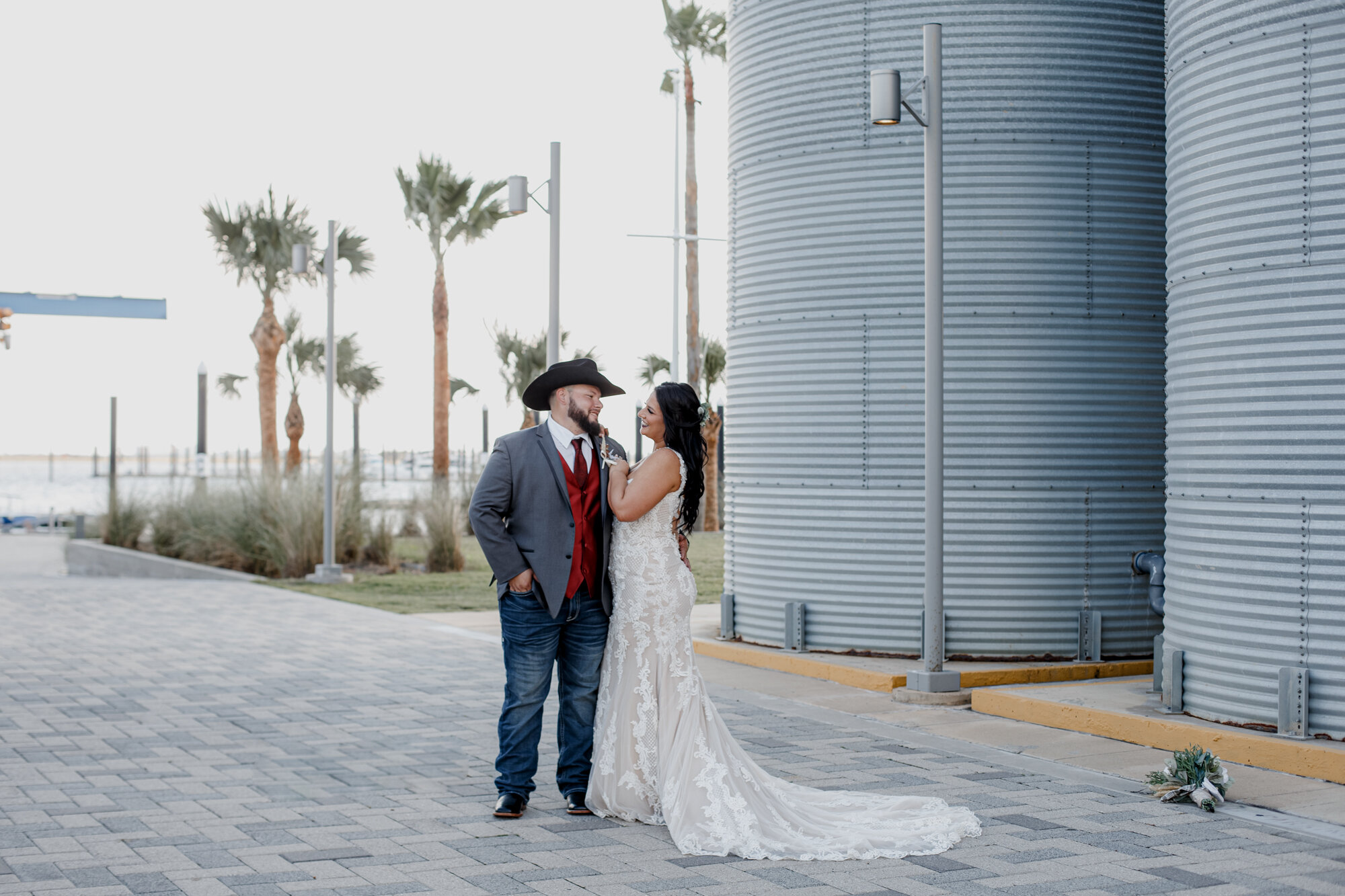 Bride and groom hugging by the venue. Fun and Glowing Wedding at Sea Star Base