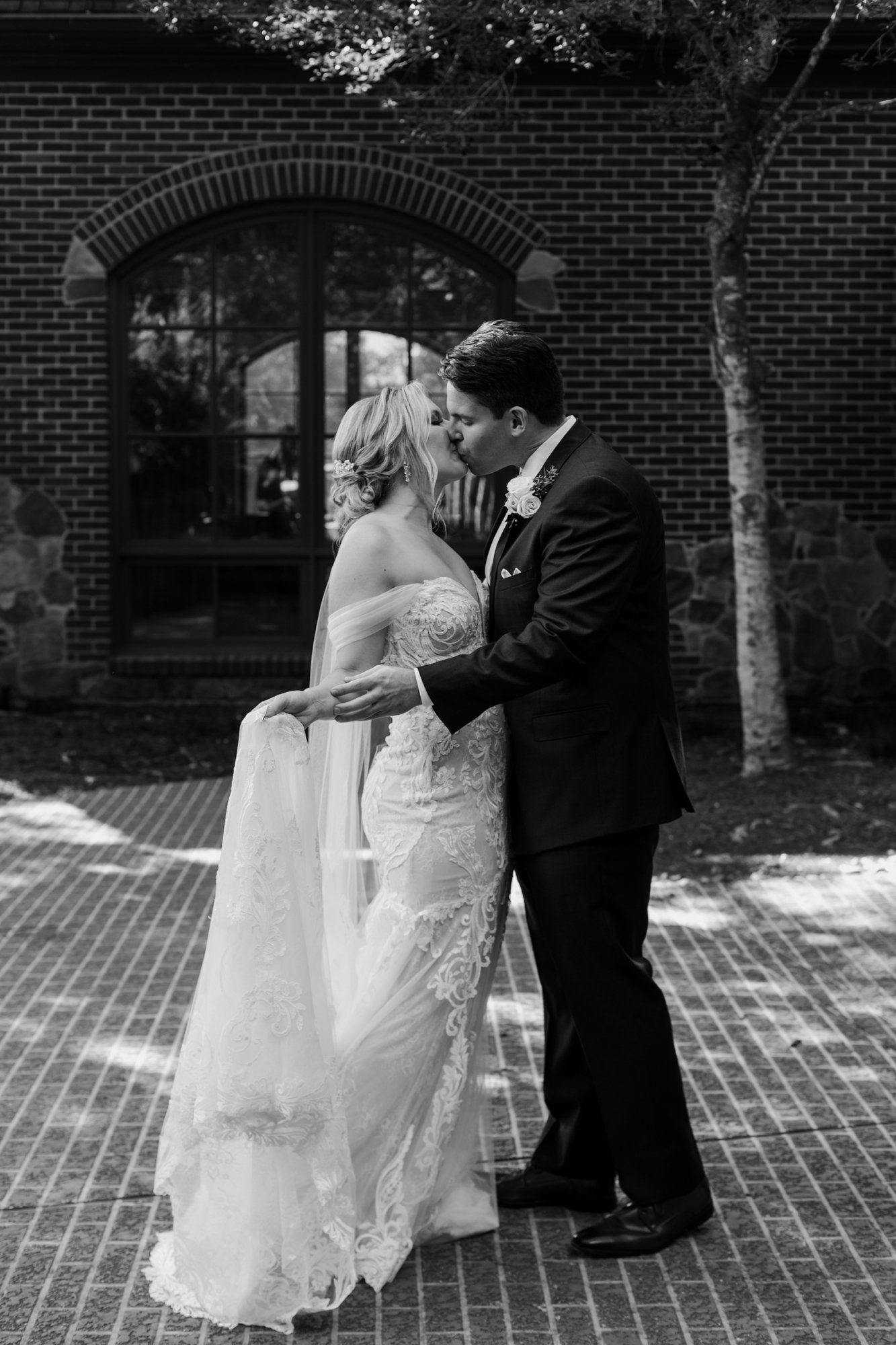Bride and groom kiss. Elegant and Glamorous Uptown Wedding at Omni Houston Hotel and The Wynden