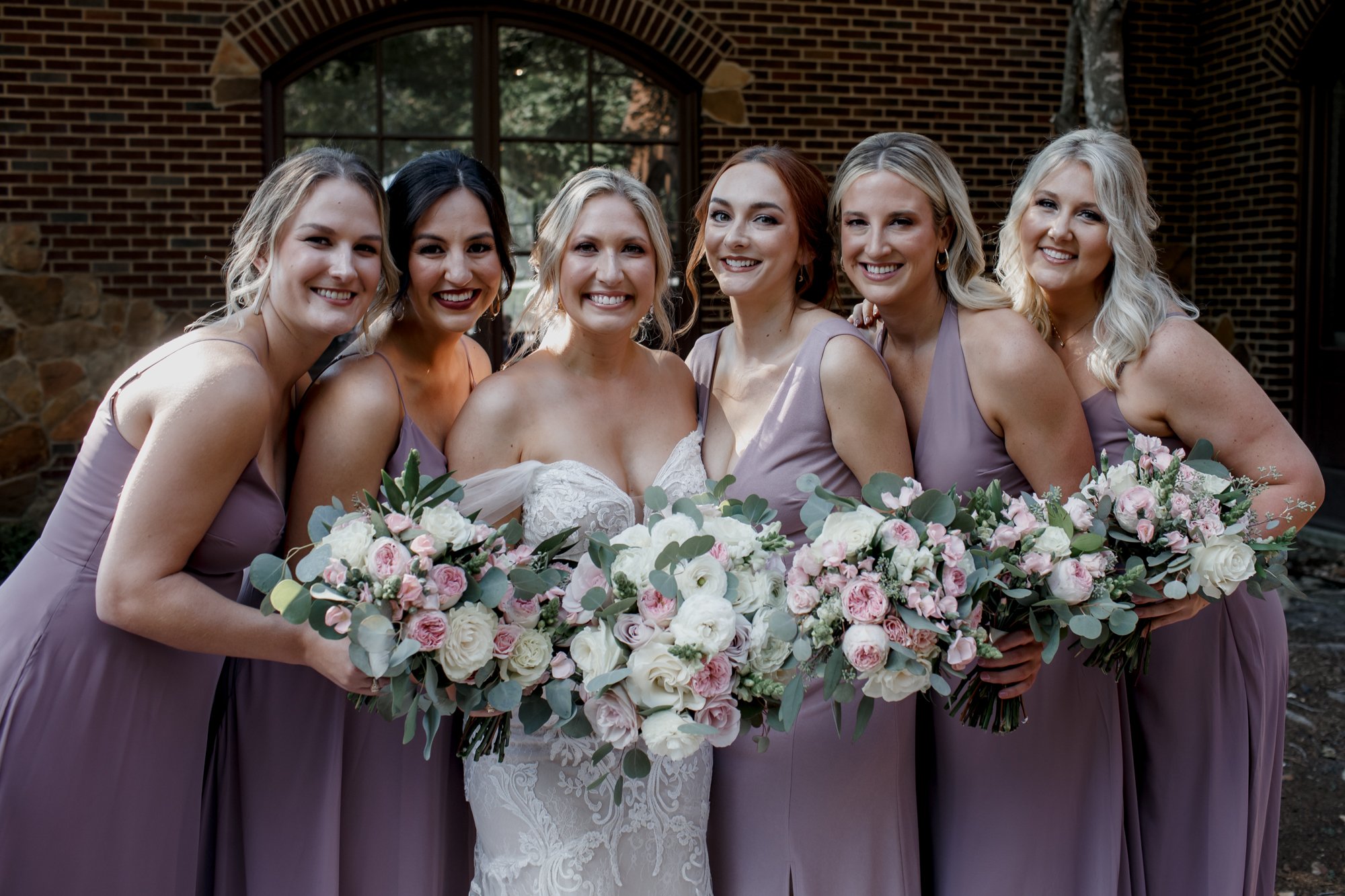 Bride and bridesmaids smiling. Elegant and Glamorous Uptown Wedding at Omni Houston Hotel and The Wynden