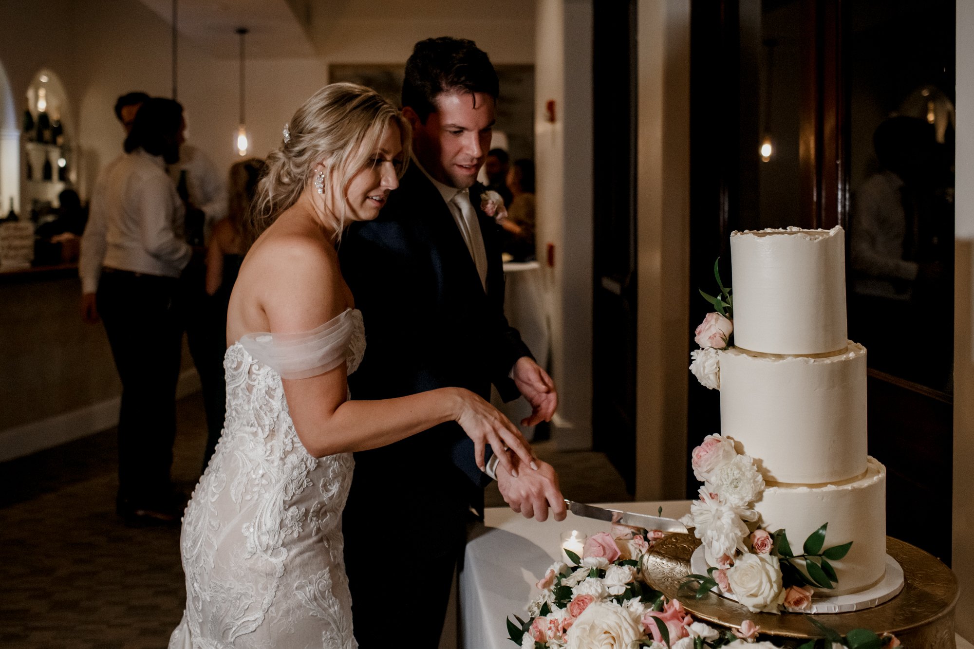 Bride and groom cake cutting. Elegant and Glamorous Uptown Wedding at Omni Houston Hotel and The Wynden