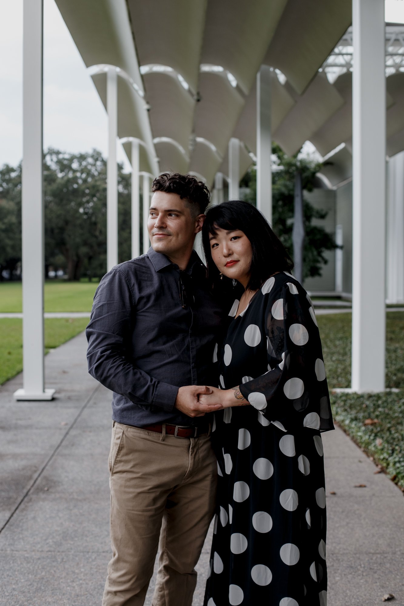 Couple holding hands head to head - Stylish Polka Dot Dress Engagement Photo Session at Menil Park