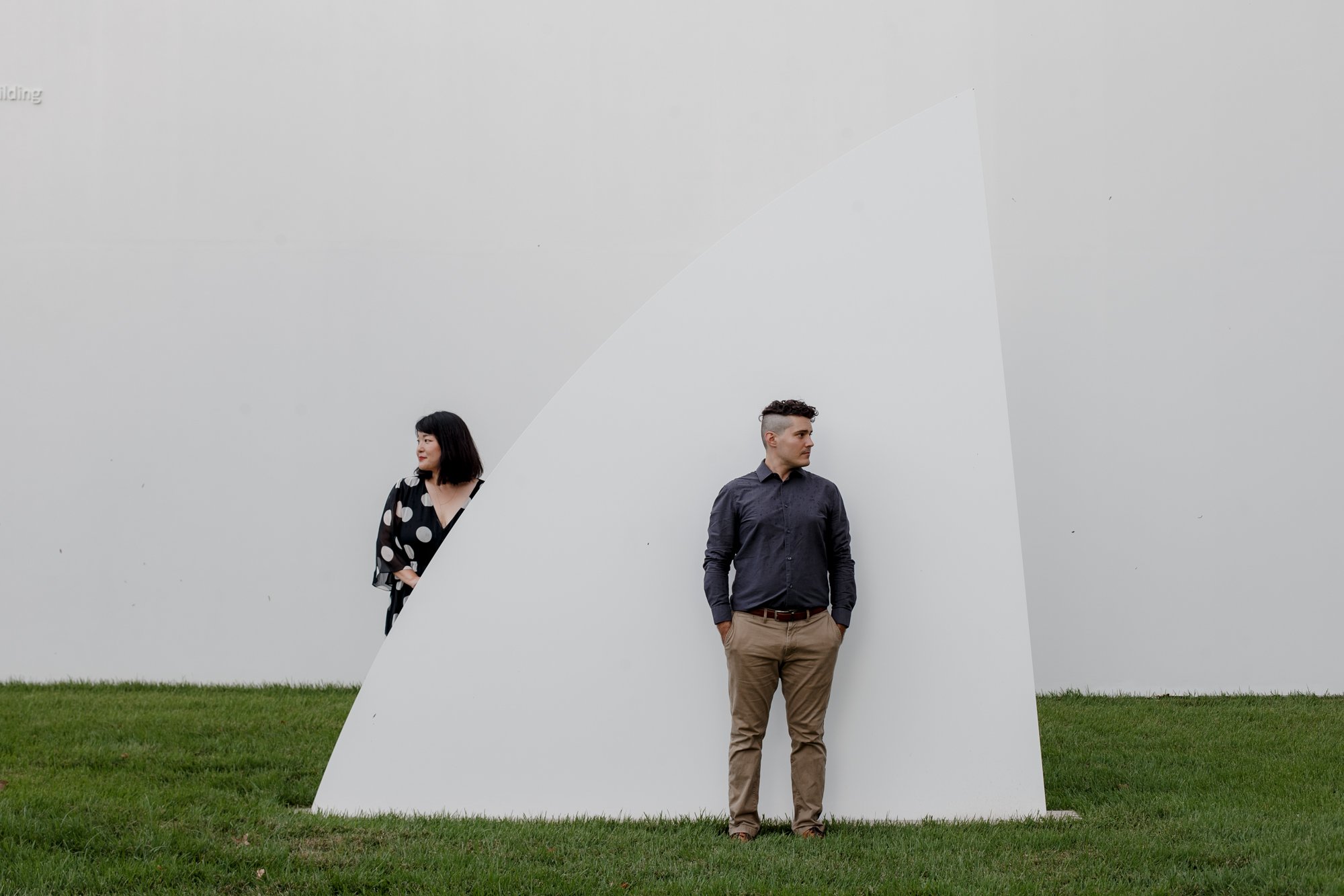 Couple posing by the drawing institute - Stylish Polka Dot Dress Engagement Photo Session at Menil Park