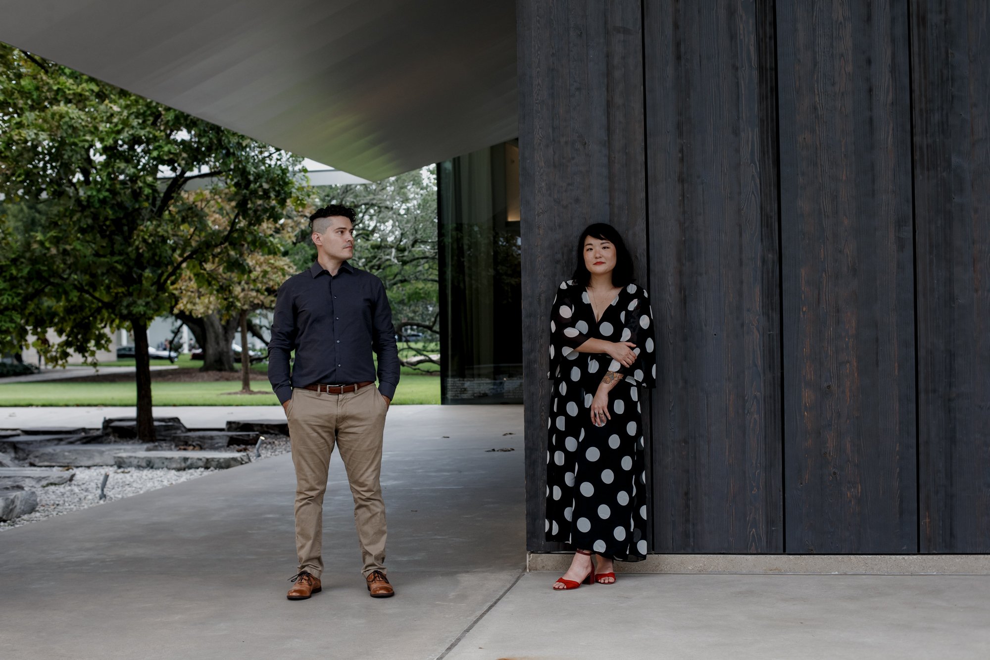 Couple posing by the drawing institute. Stylish Polka Dot Dress Engagement Photo Session at Menil Park