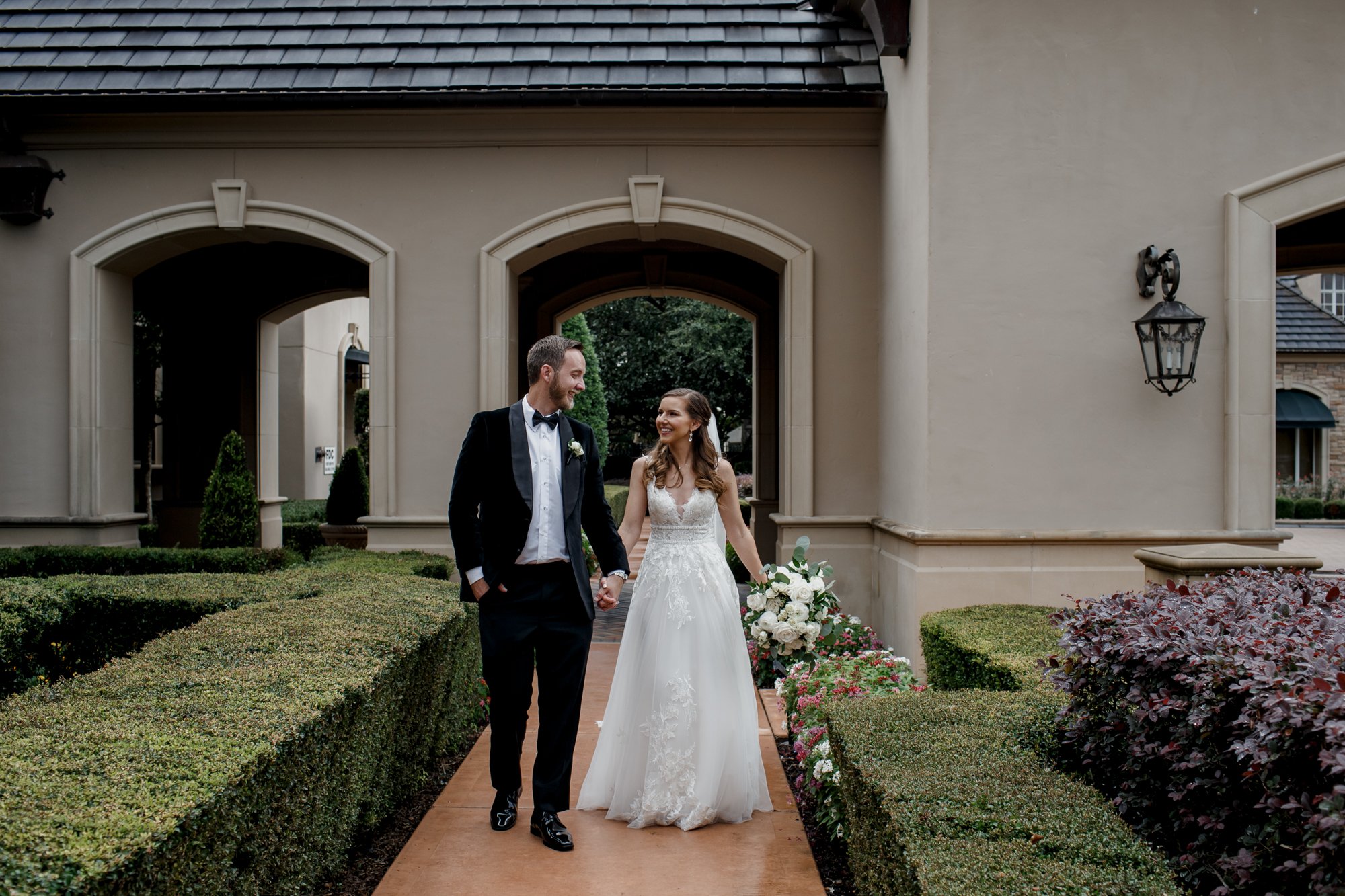 Bride and groom walking hand in hand. Wedding at Royal Oaks Country Club