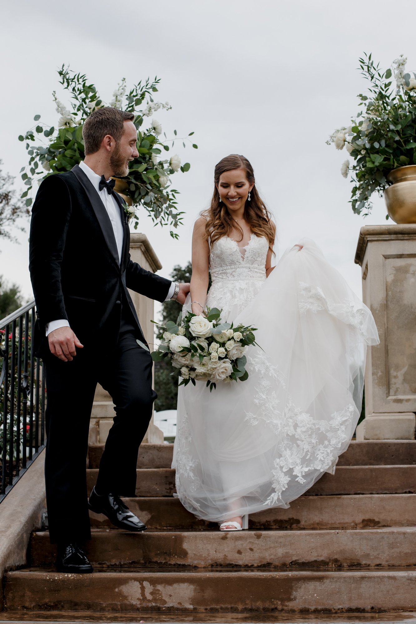 Bride and groom walking down the stairs. Wedding at Royal Oaks Country Club