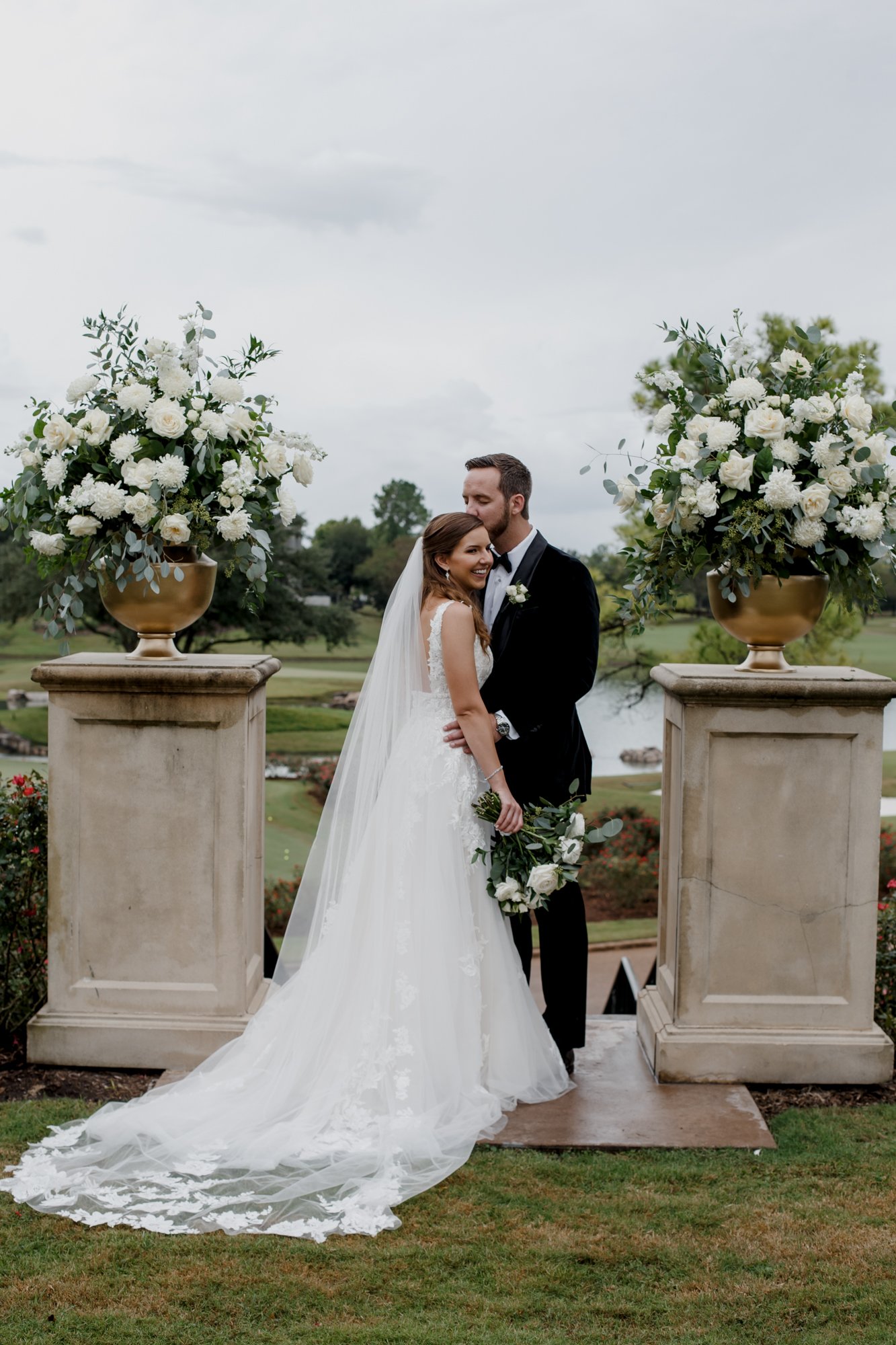 Bride and groom princess kiss. Wedding at Royal Oaks Country Club