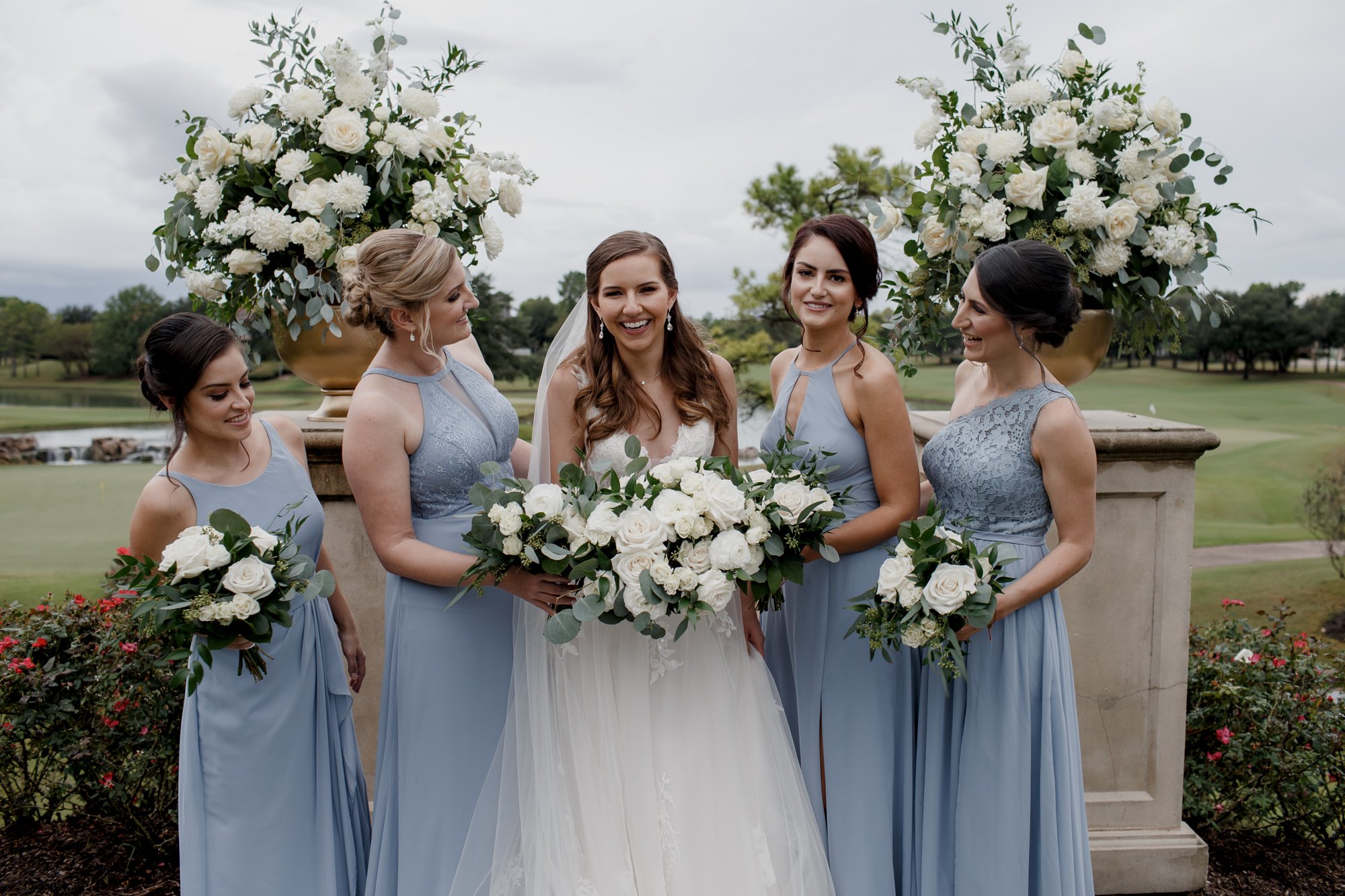 Bridesmaids looking at bride. Wedding at Royal Oaks Country Club