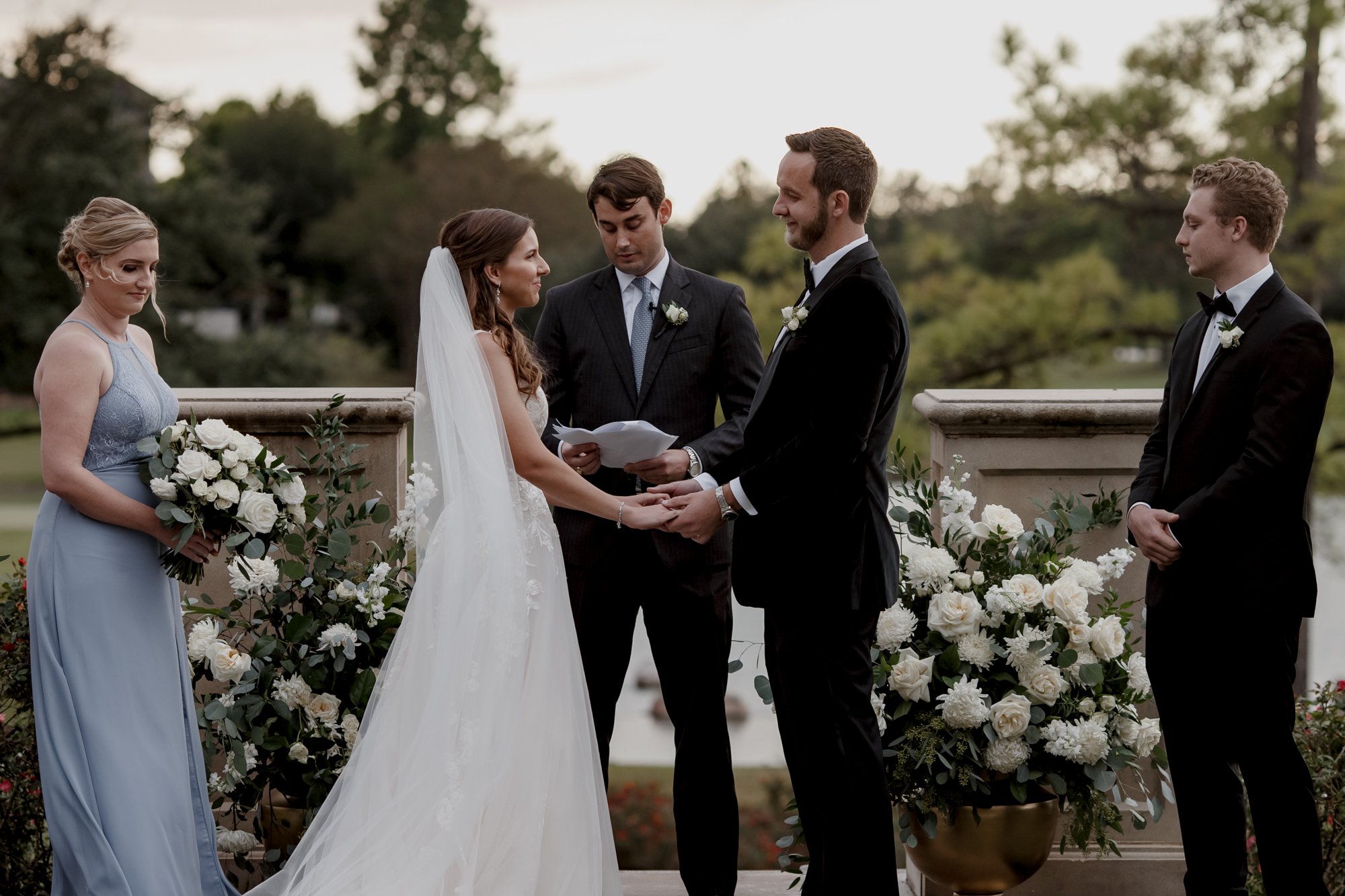 Bride and groom holding hands. Wedding Ceremony at Royal Oaks Country Club