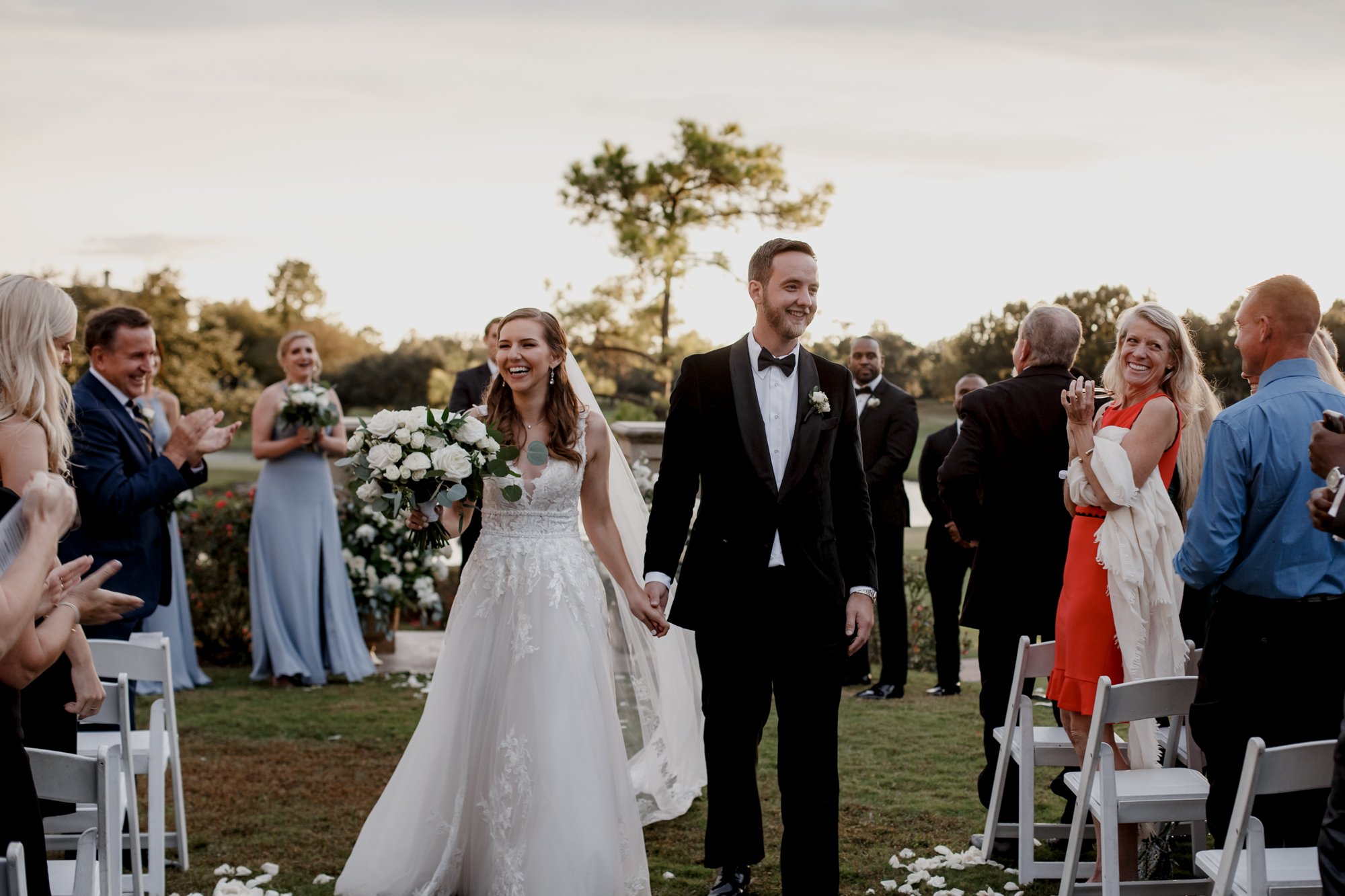 Bride and groom walking down the aisle. Wedding at Royal Oaks Country Club