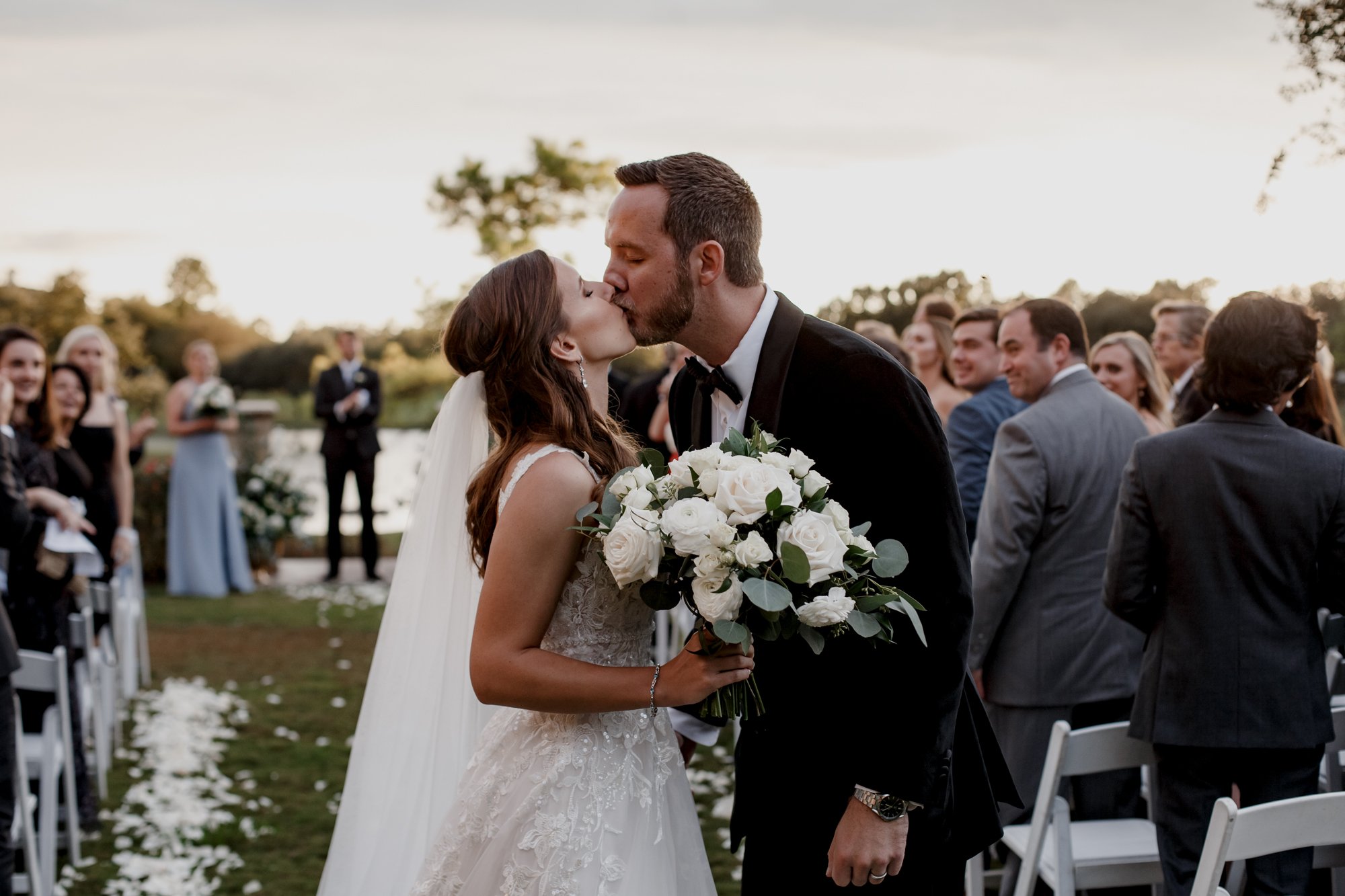 Bride and groom exit kiss. Wedding at Royal Oaks Country Club