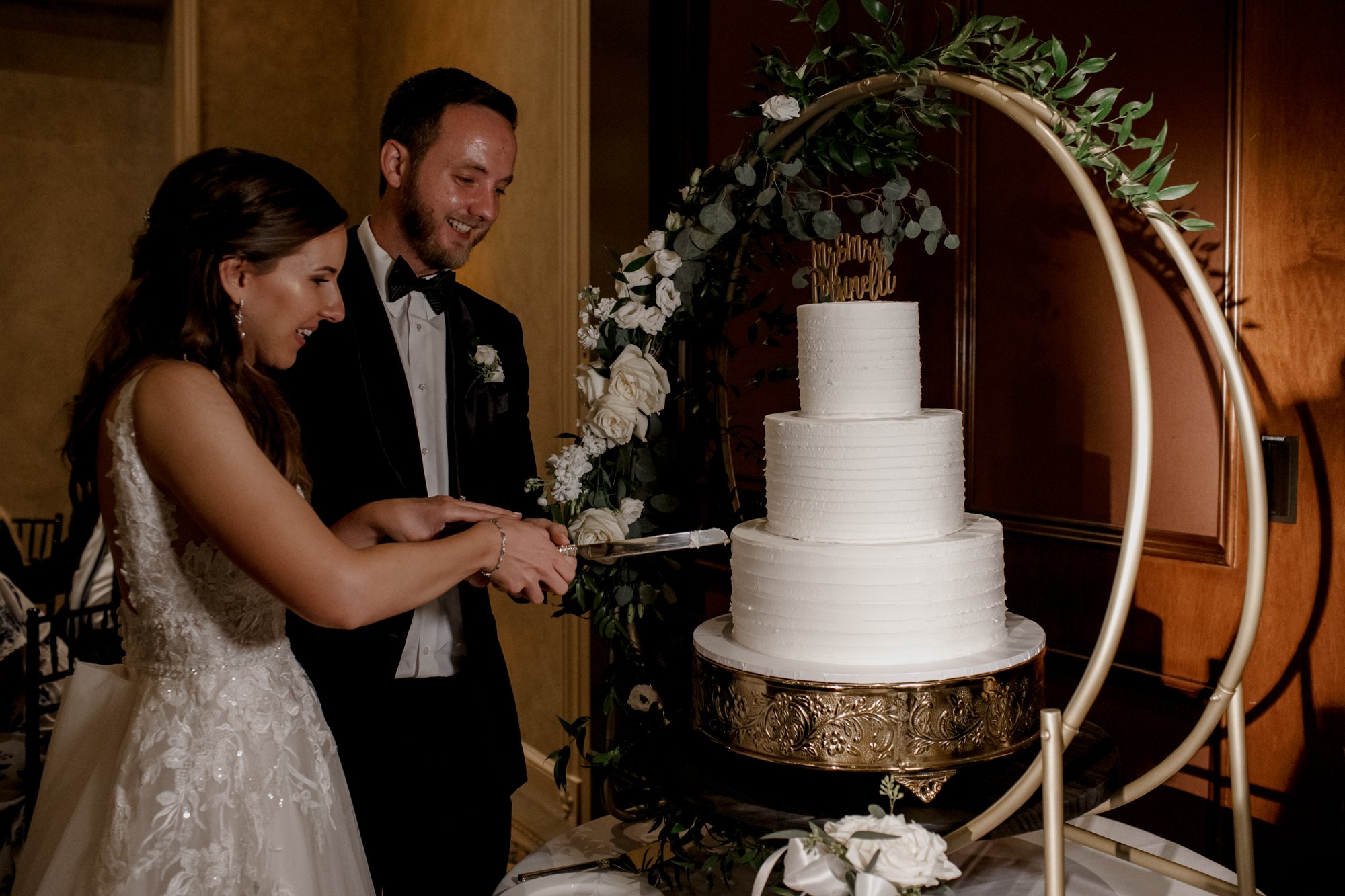 Bride and groom cutting the cake. Wedding reception at Royal Oaks Country Club