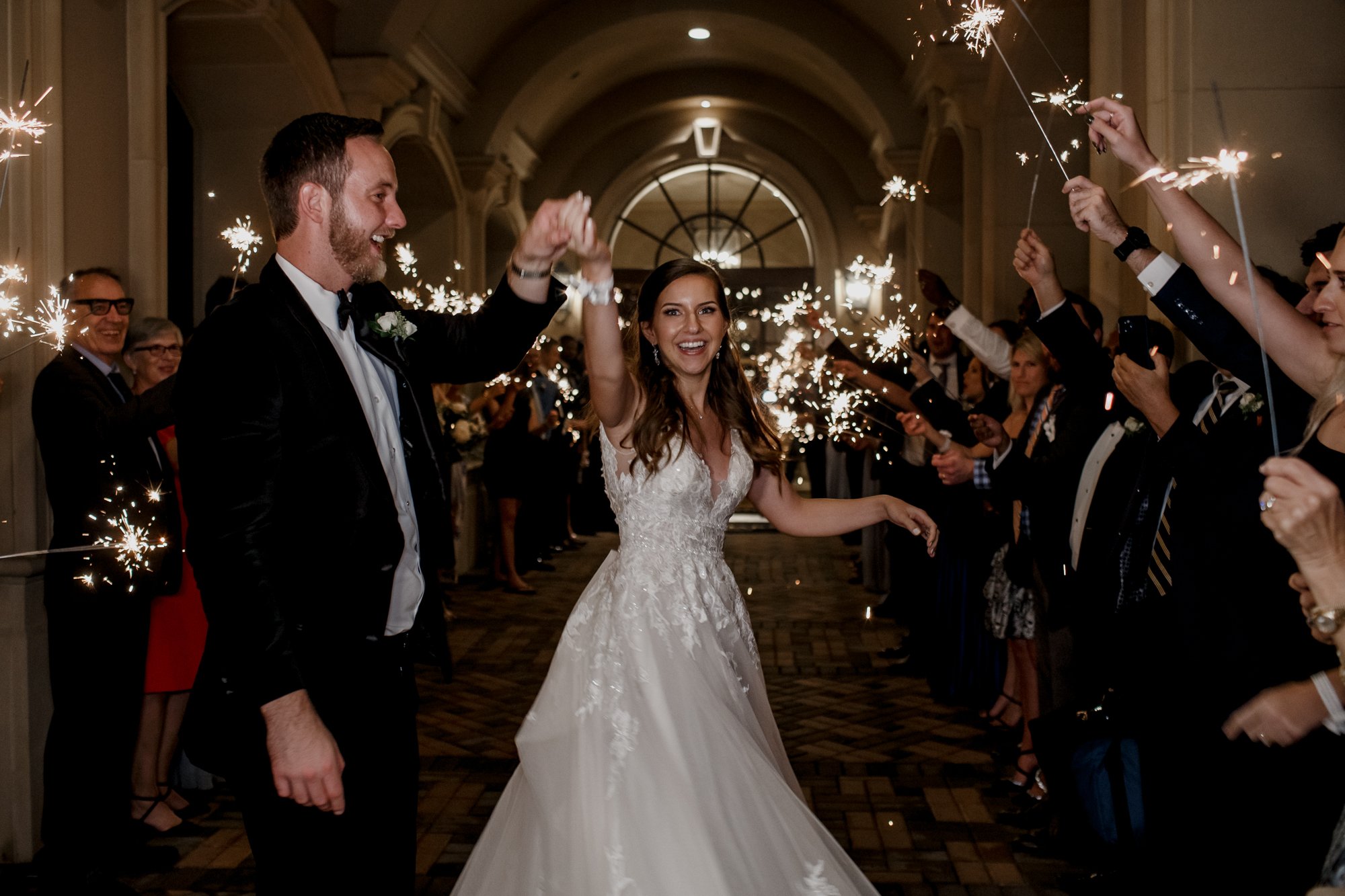 Grand exit send off with sparklers. Wedding at Royal Oaks Country Club