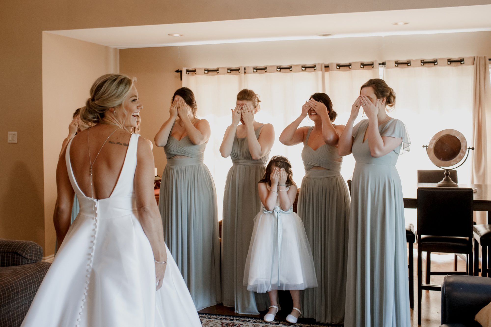 Bride first look with bridesmaids. Wedding at Shirley Acres