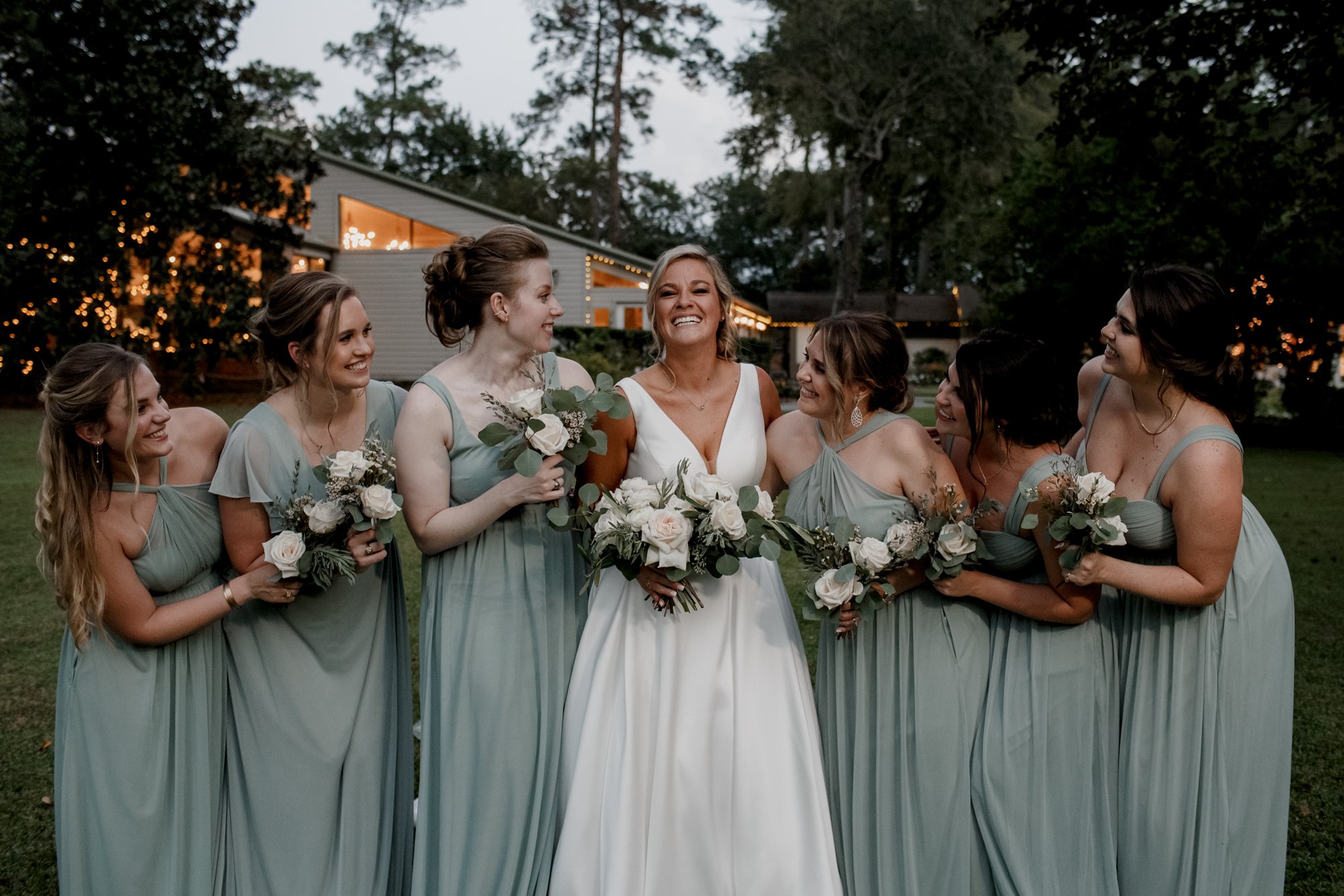 Bride and bridesmaids laugh looking at each other Wedding at Shirley Acres