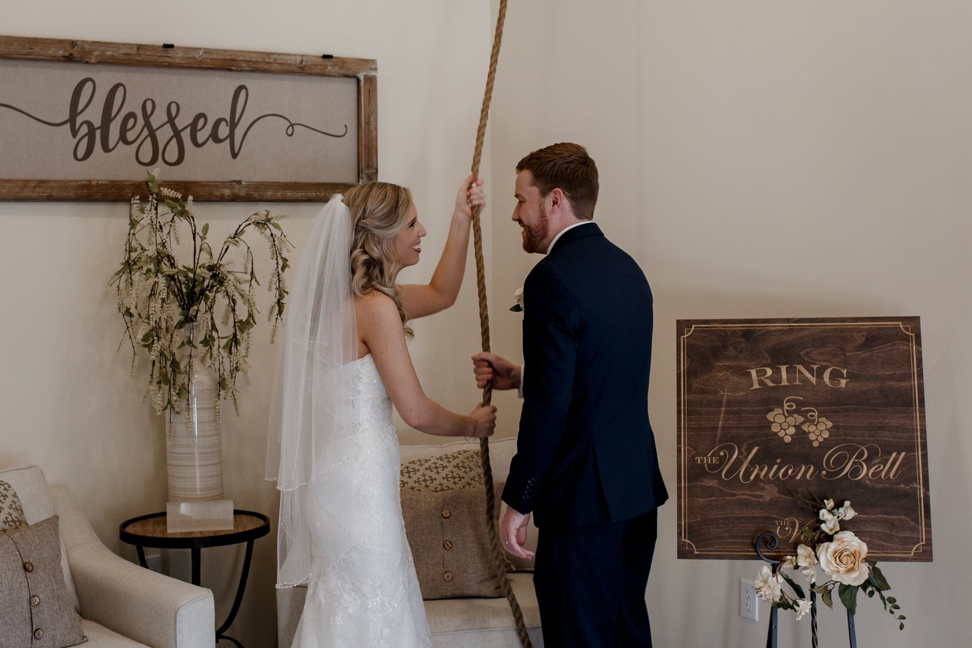 Bride and groom ringing the bell. Wedding at The Vine (New Ulm, TX)
