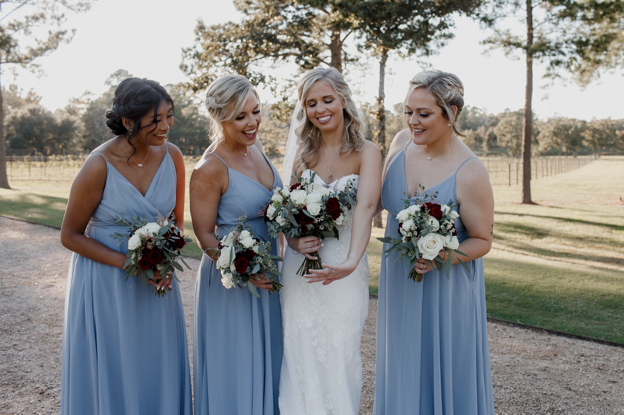 Bride and bridesmaids wearing sky blue dresses. Wedding at The Vine (New Ulm, TX)