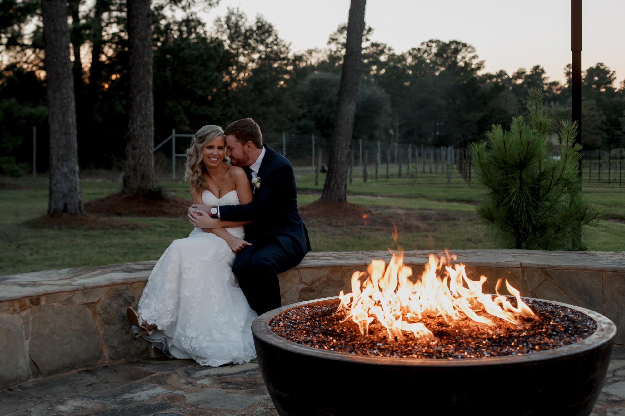 Bride and groom by the fire. Wedding at The Vine (New Ulm, TX)