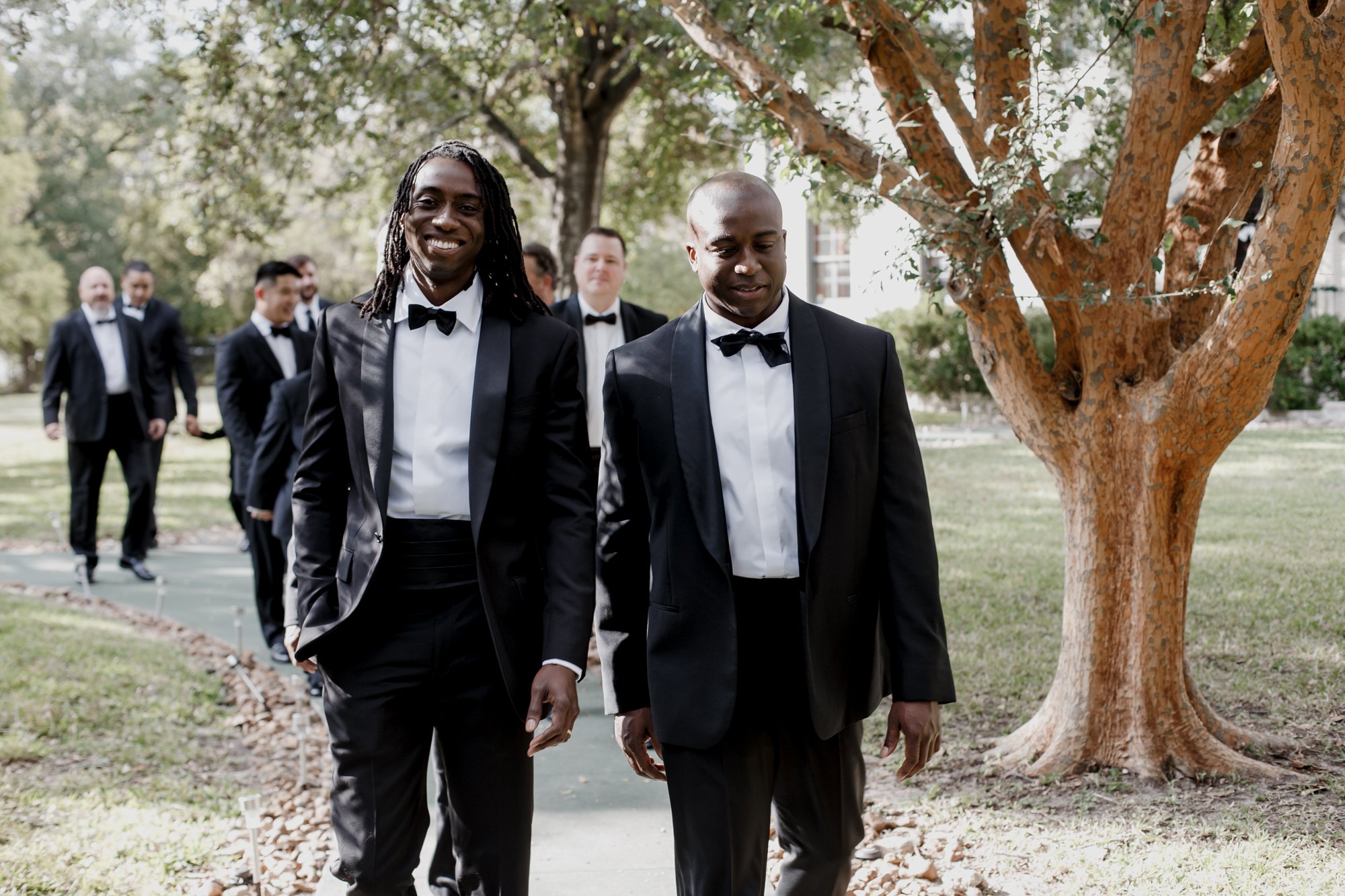 Private house groom and groomsmen walking smiling. New Orleans Style Wedding at McGovern Centennial Gardens