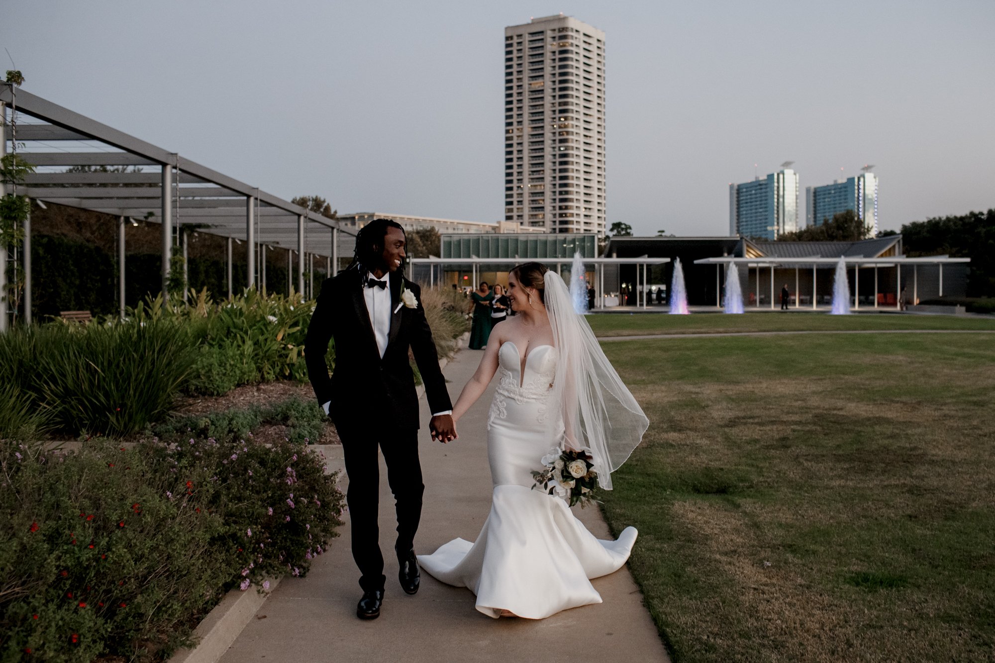 Bride and groom walking holding hands - Wedding at McGovern Centennial Gardens