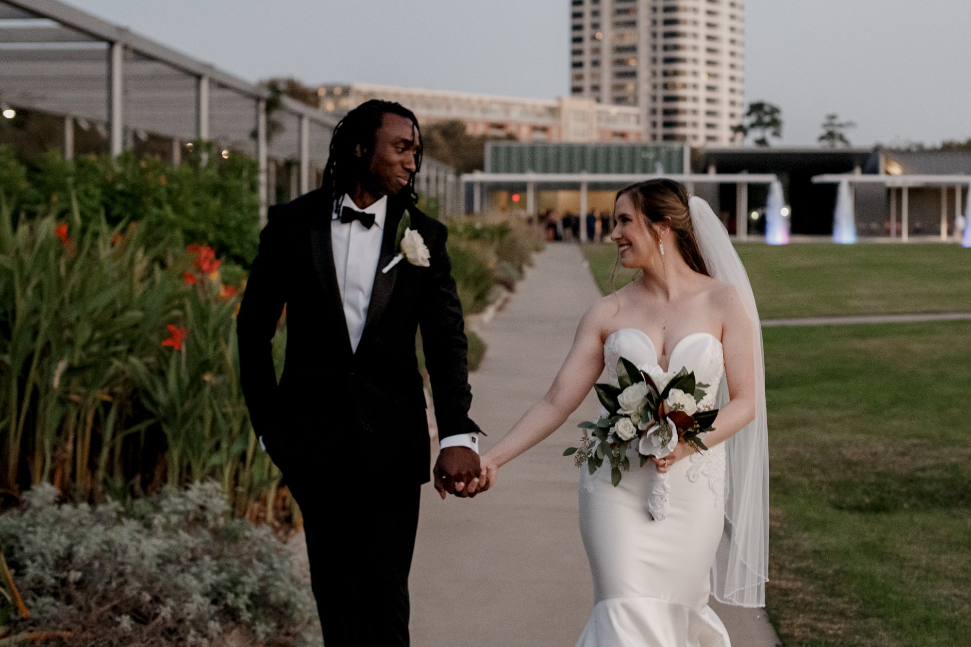 Bride and groom walking smiling Wedding at McGovern Centennial Gardens