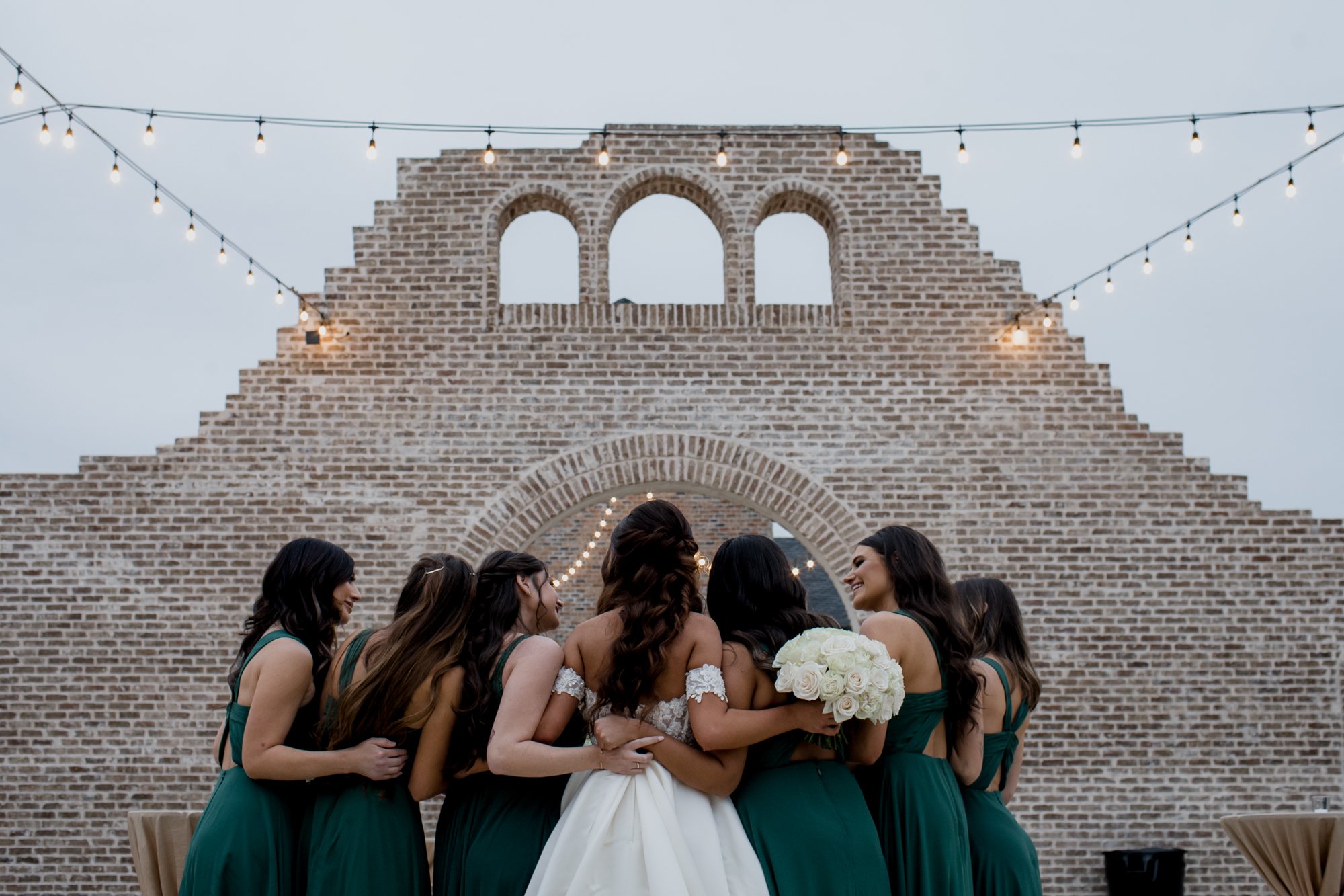 Bride and bridesmaids from the back. Wedding at Iron Manor (Montgomery, TX)