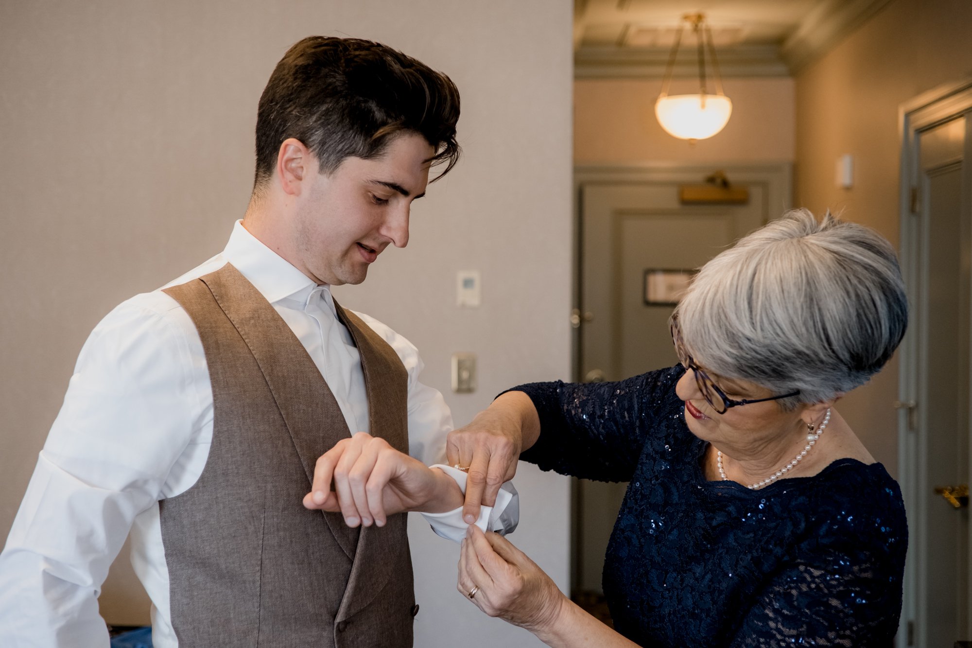 Groom preparations getting ready with mother. Wedding at Hotel Icon
