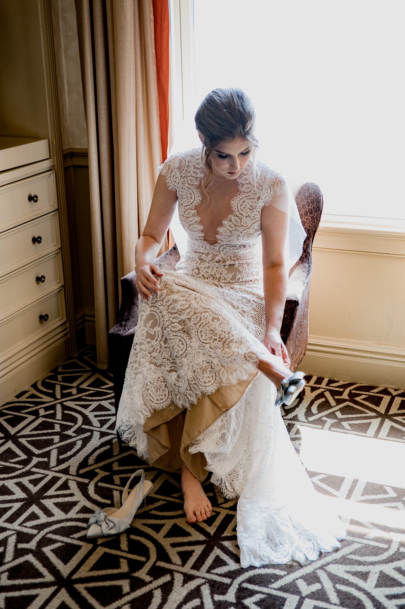 Bridal putting shoes on. Wedding at Hotel Icon