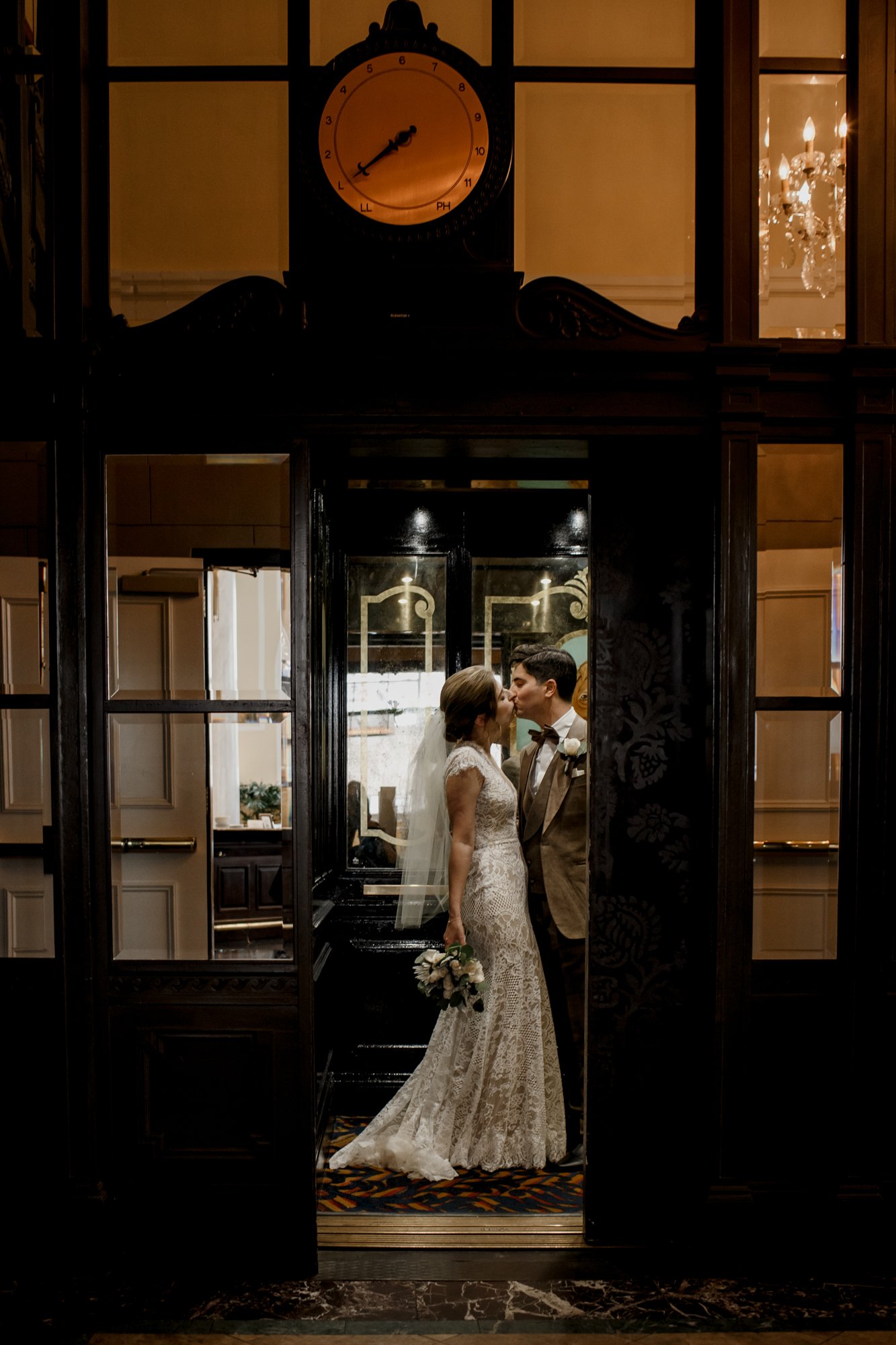 Bride and groom kiss in the elevator. Wedding at Hotel Icon