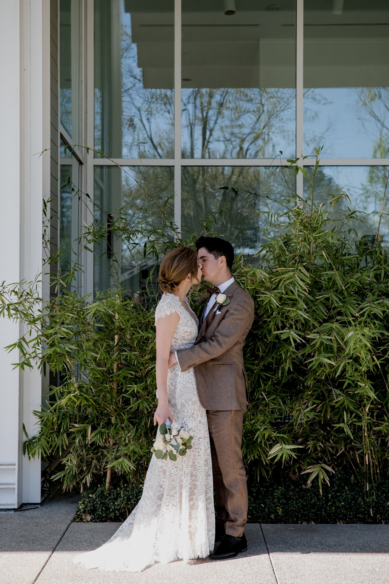 Wedding bride and groom couples portraits kissing by the bamboo at  Menil Park
