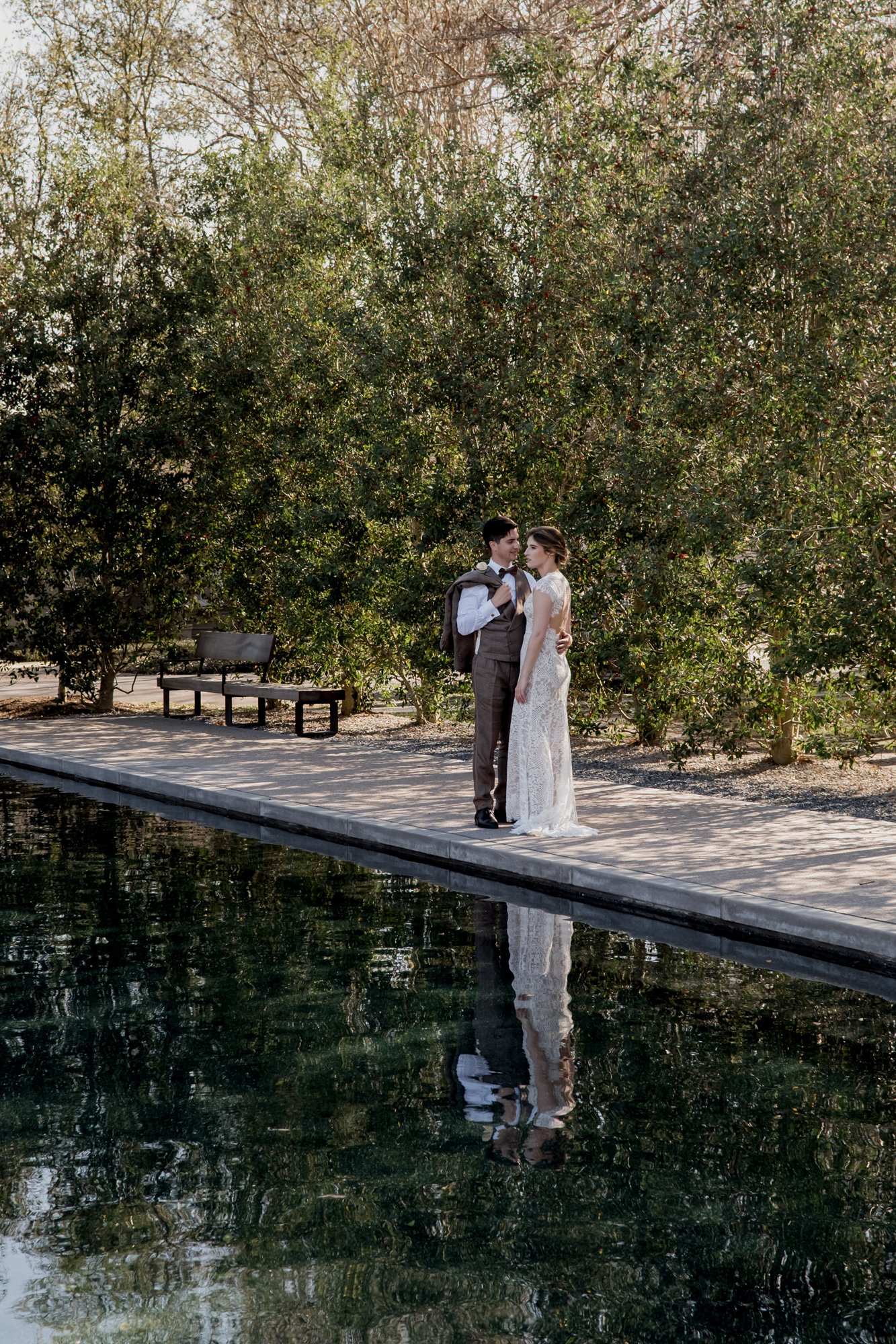 Wedding bride and groom portraits at Menil Park by the Rothko Chapel Pool