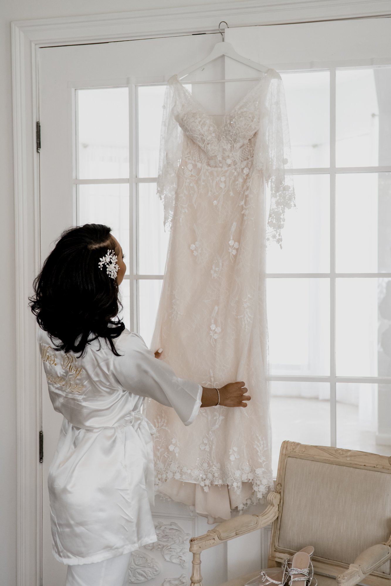Bride looking at her wedding gown. Wedding at The Oak Atelier