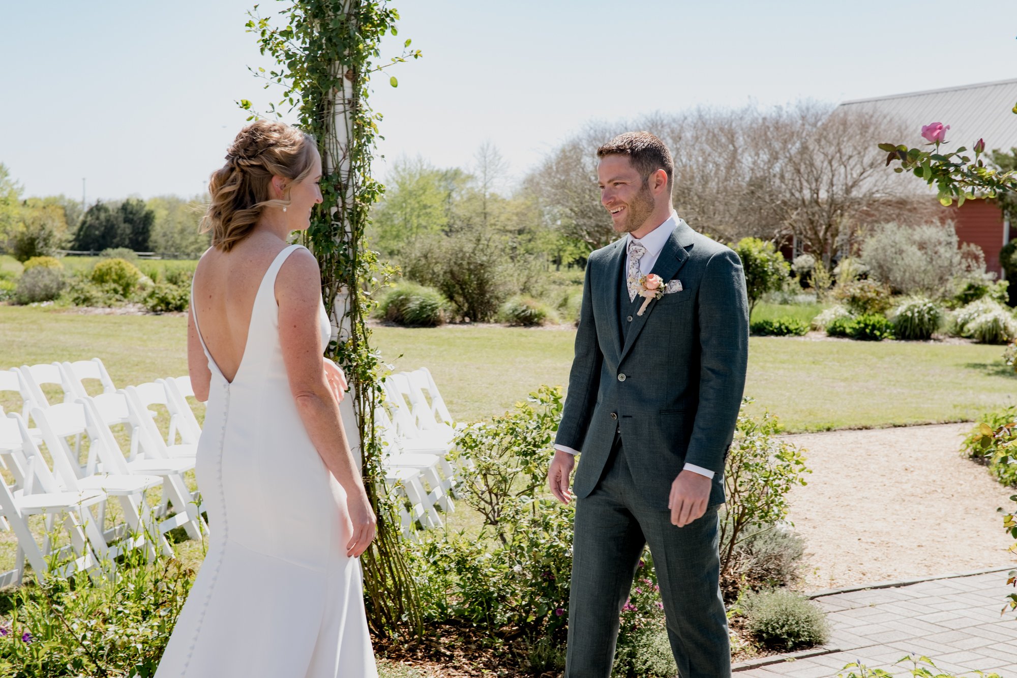 Groom's reaction when he sees the bride - first look. Wedding at Antique Rose Emporium