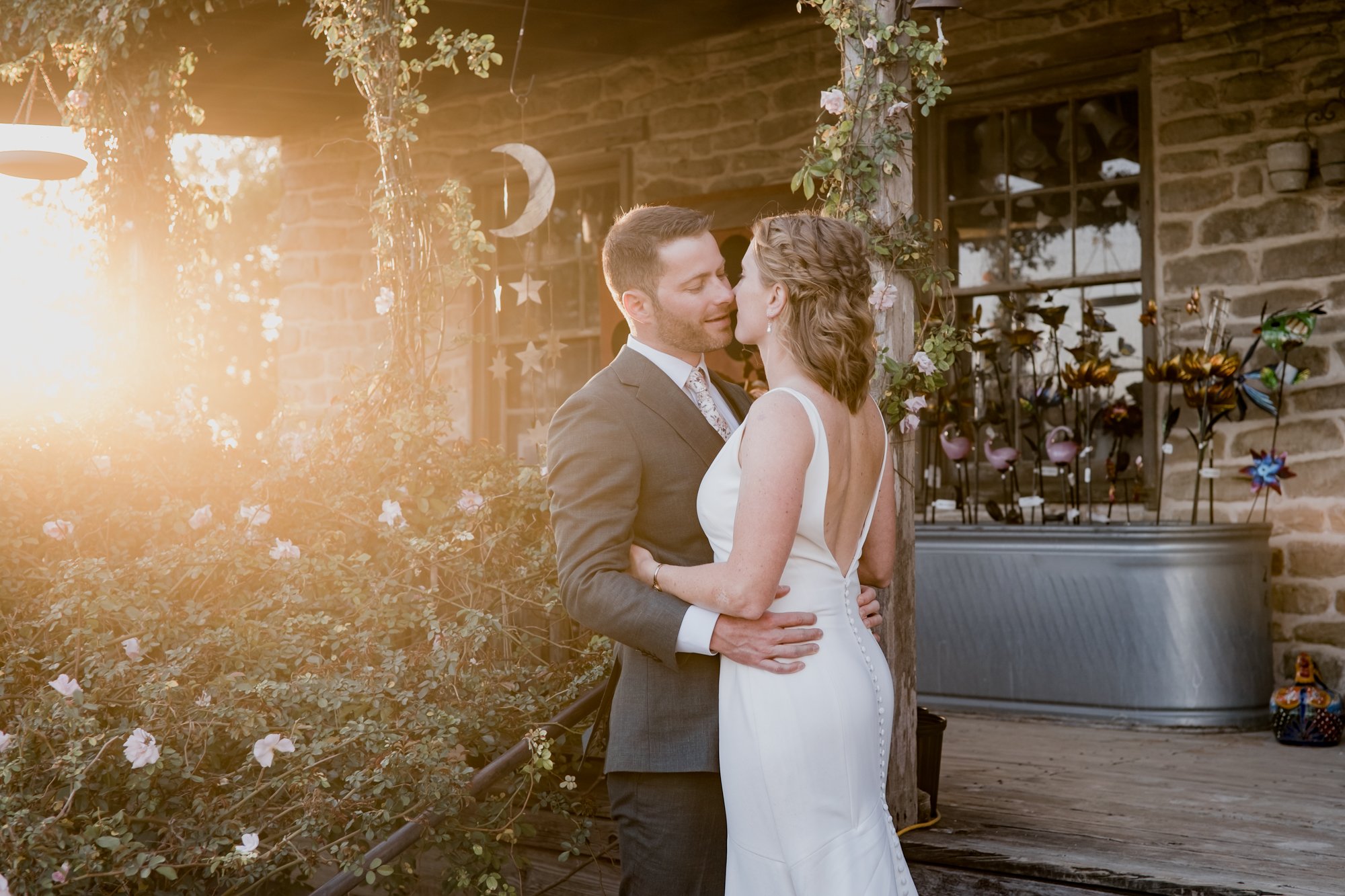 Bride and groom golden hour with the stars and the moon wind chime. Wedding at Antique Rose Emporium