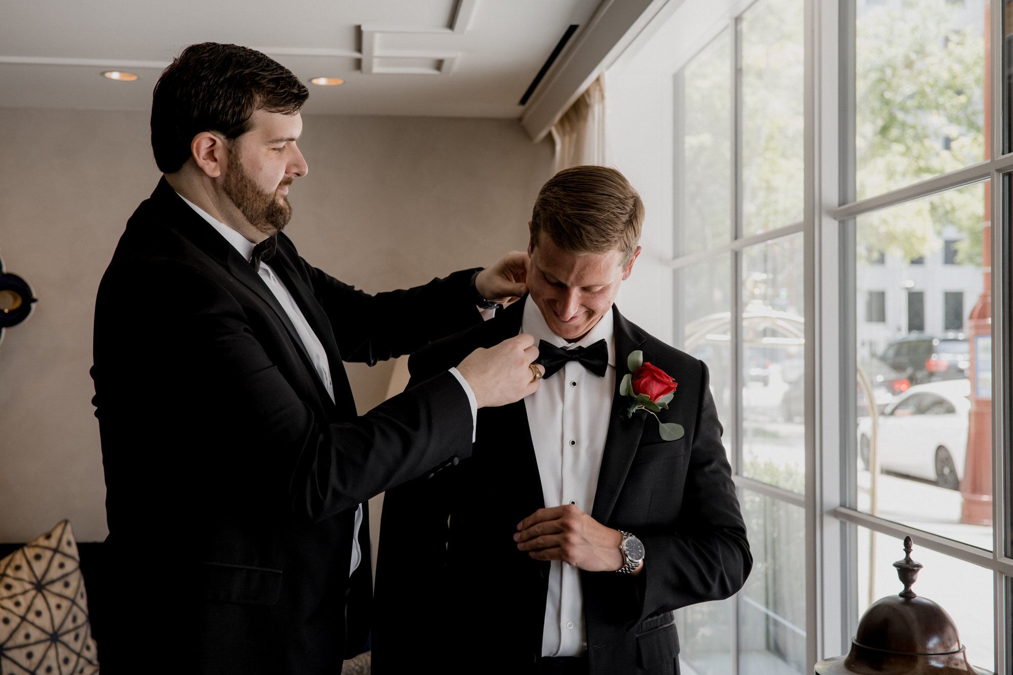 Best Man helping Groom put the jacket on at Lancaster Hotel