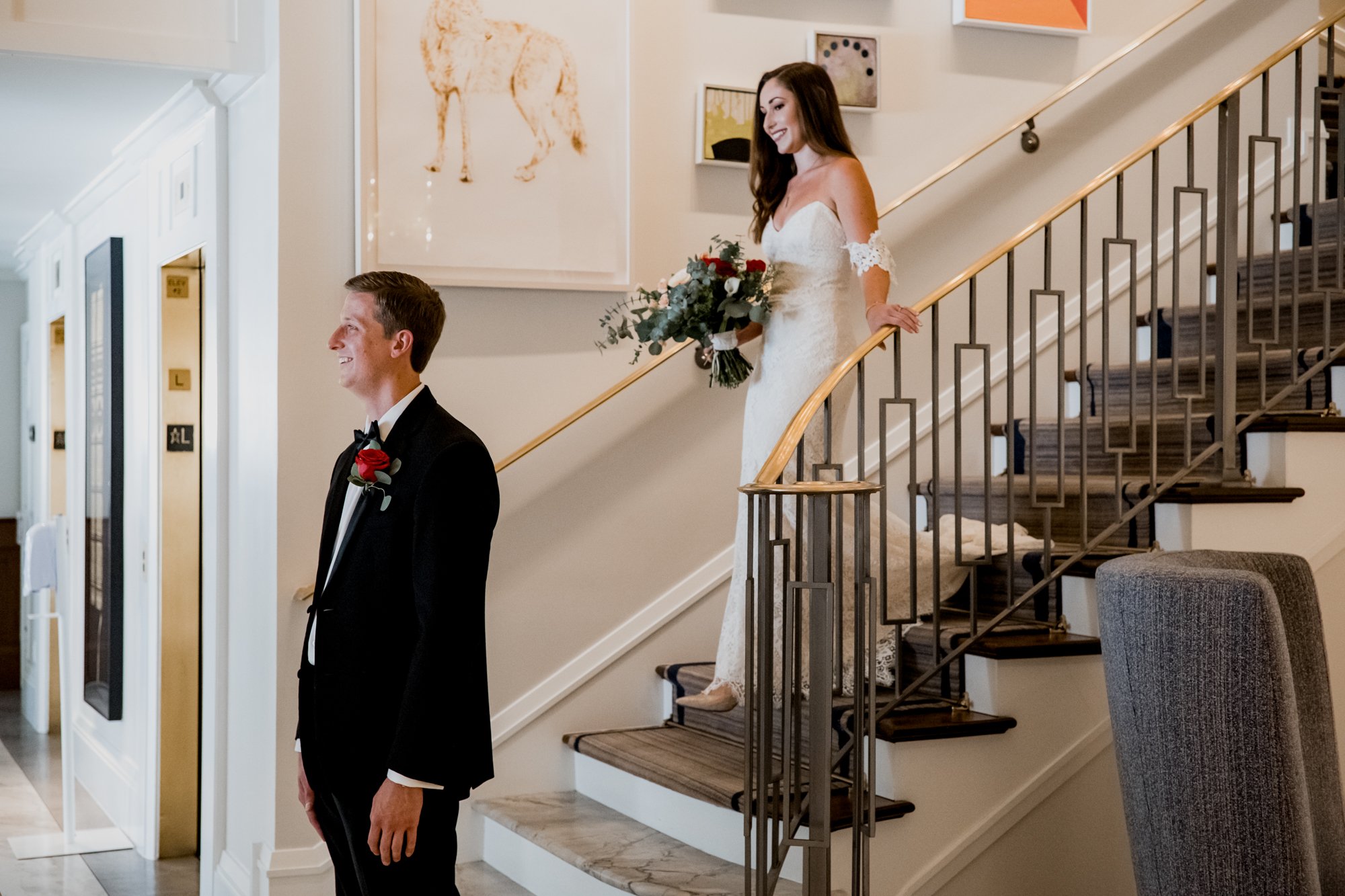 First look bride and groom on a staircase at Lancaster Hotel