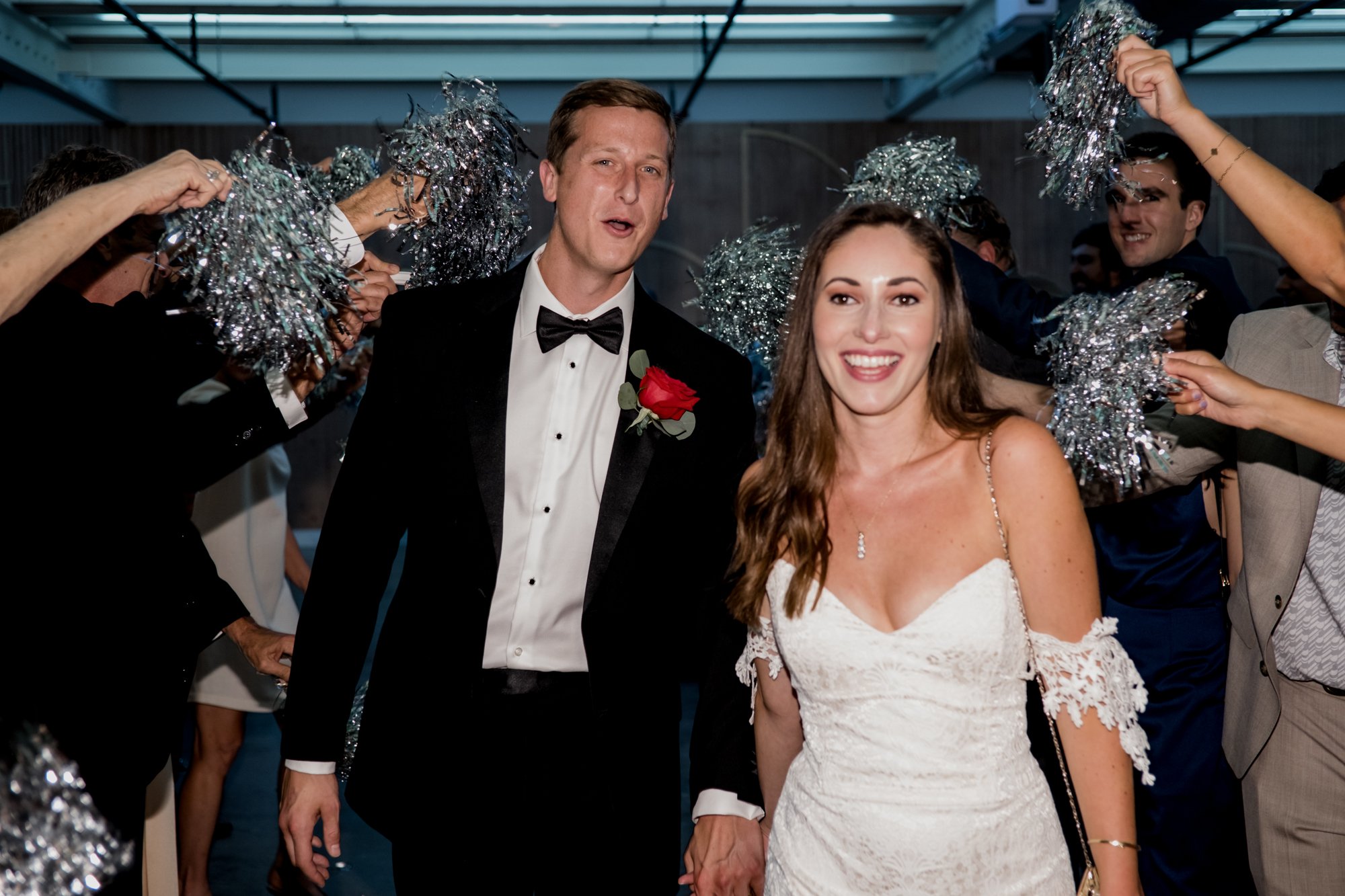 Grand exit bride and groom send off with silver pom poms at Ronin Harrisburg