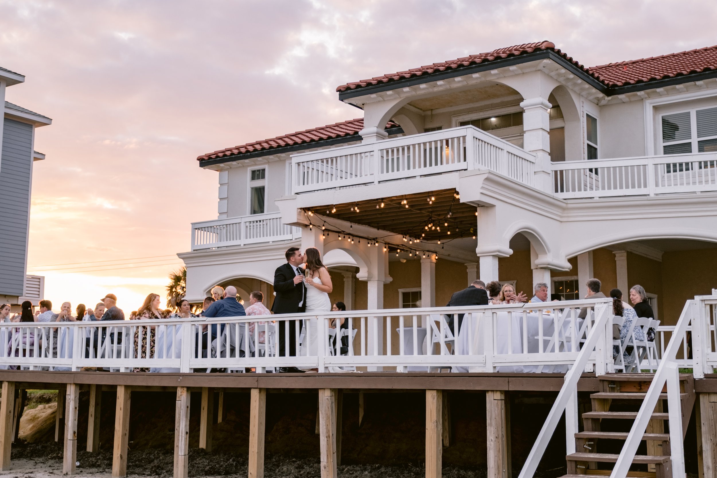 Sunset wedding toast on the beach patio Galveston Wedding
