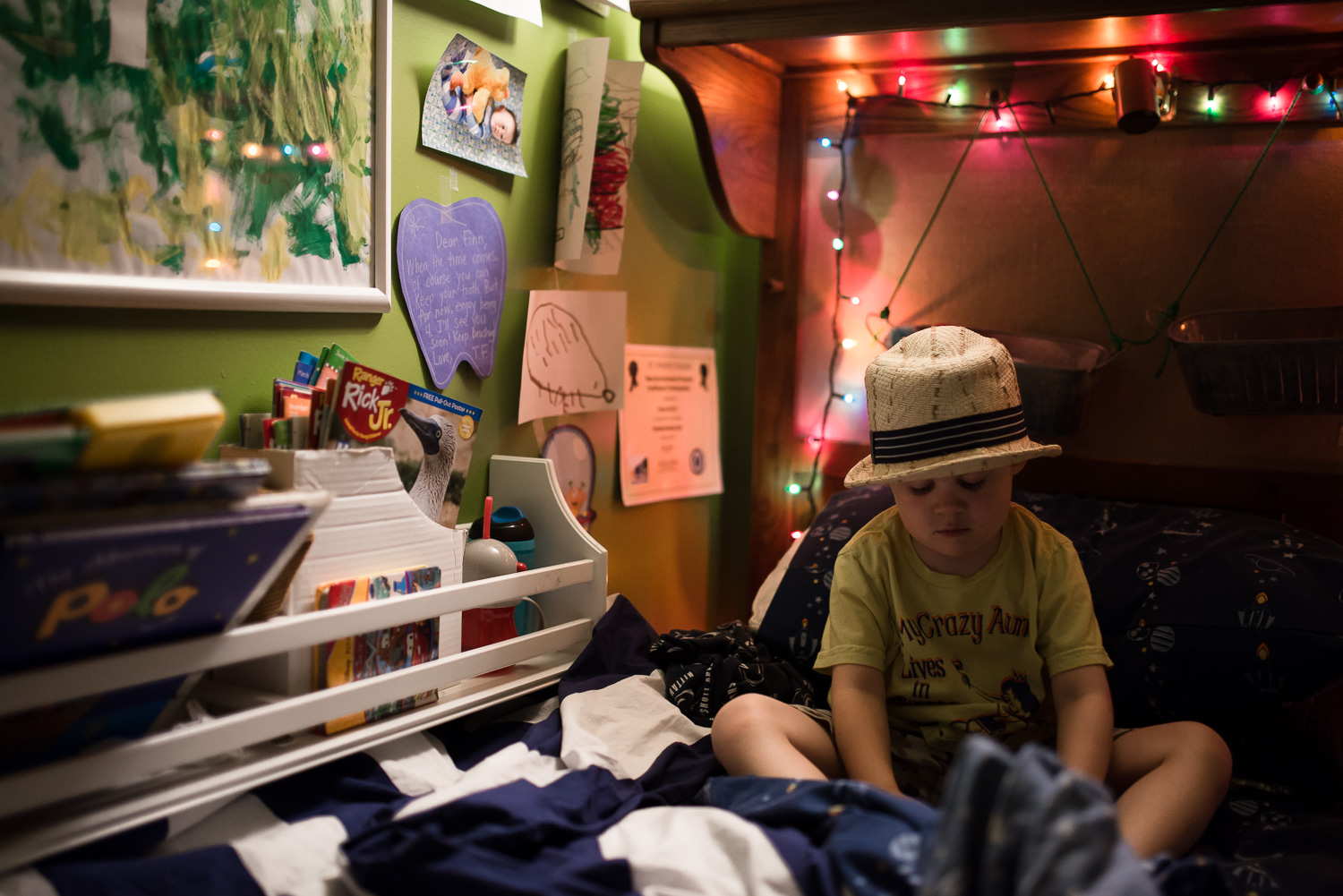 My oldest son right before bedtime last summer. Instead of filling the frame with him, I backed up and included his treasures. (Shot with the Nikon D800)