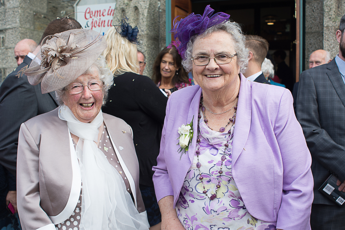 two grans smile outside church in Porthleven