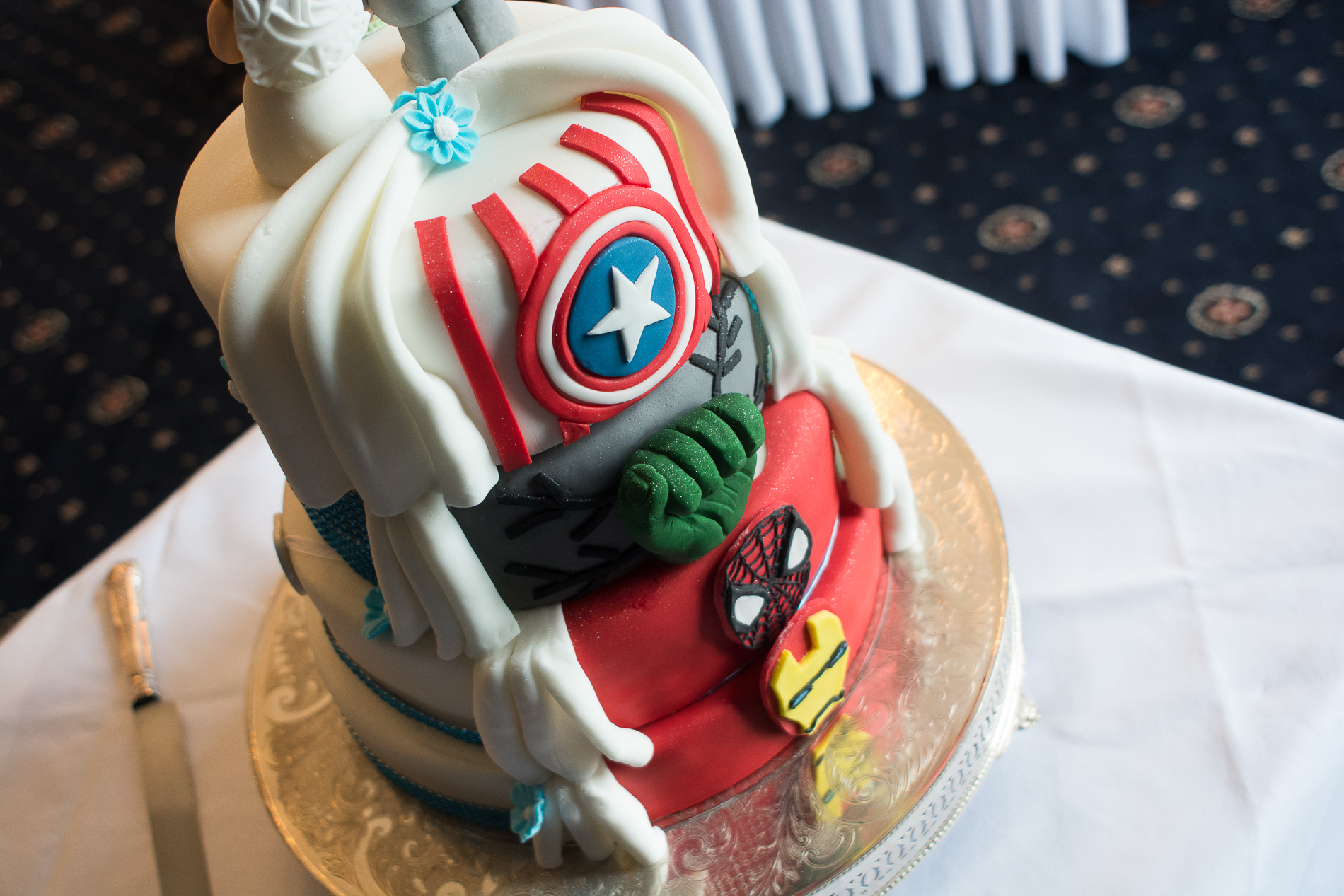 awesome wedding cake with a hidden marvel theme at the back