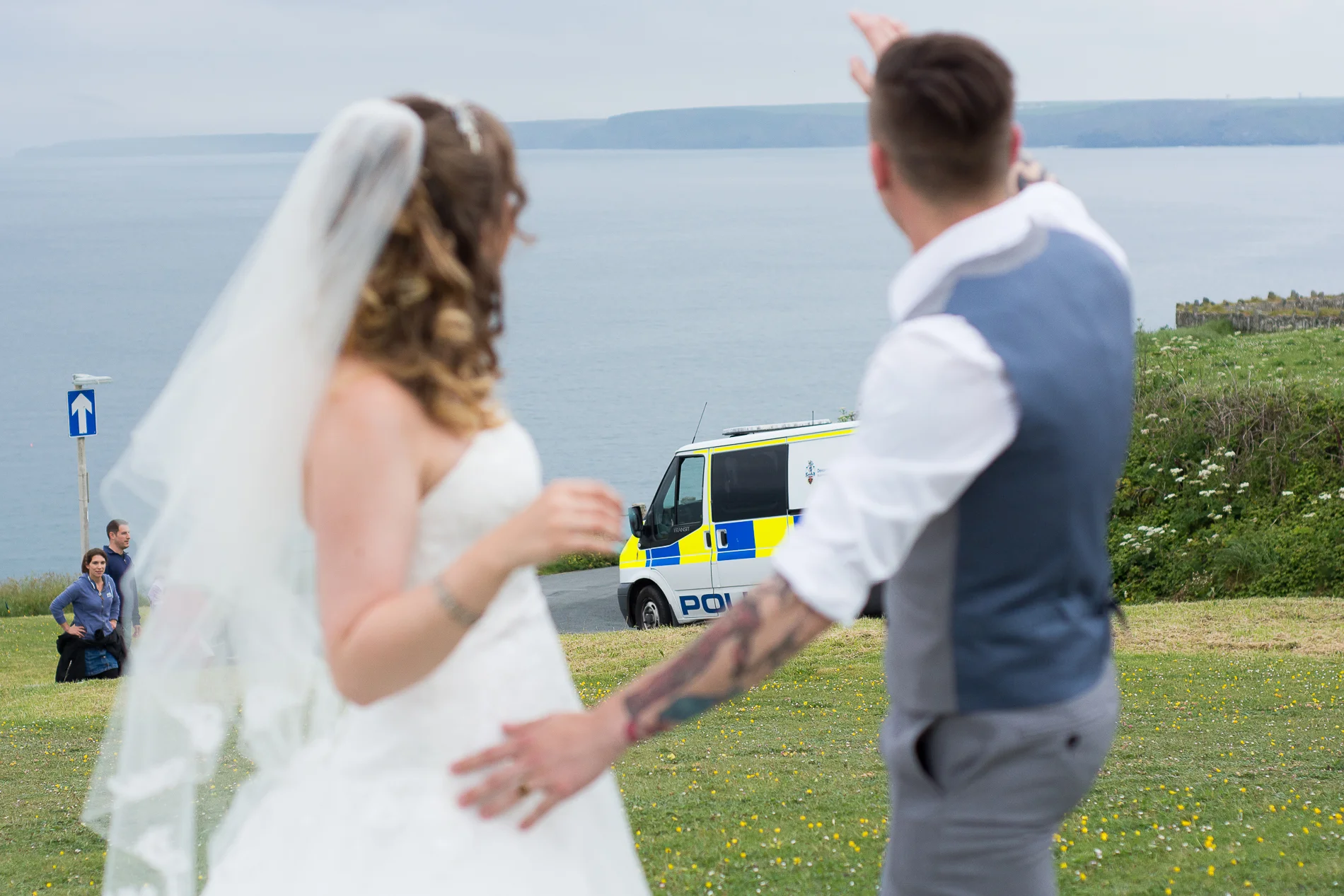 bride and groom wave to the police outside the Atlantic Hotel in Newquay