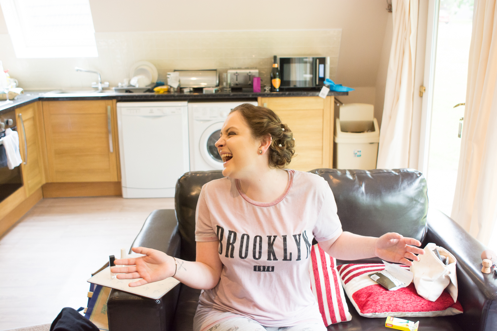 bridesmaid laughing and drying nails at waterside cornwall