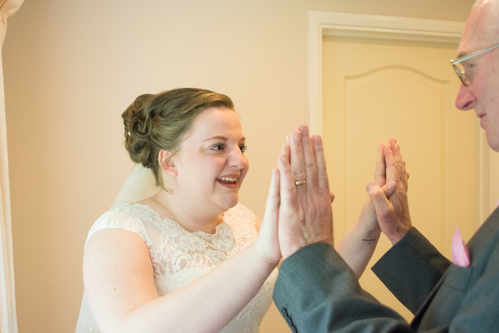 proud grandad and granddaughter have an emotional moment before the wedding at waterside cornwall