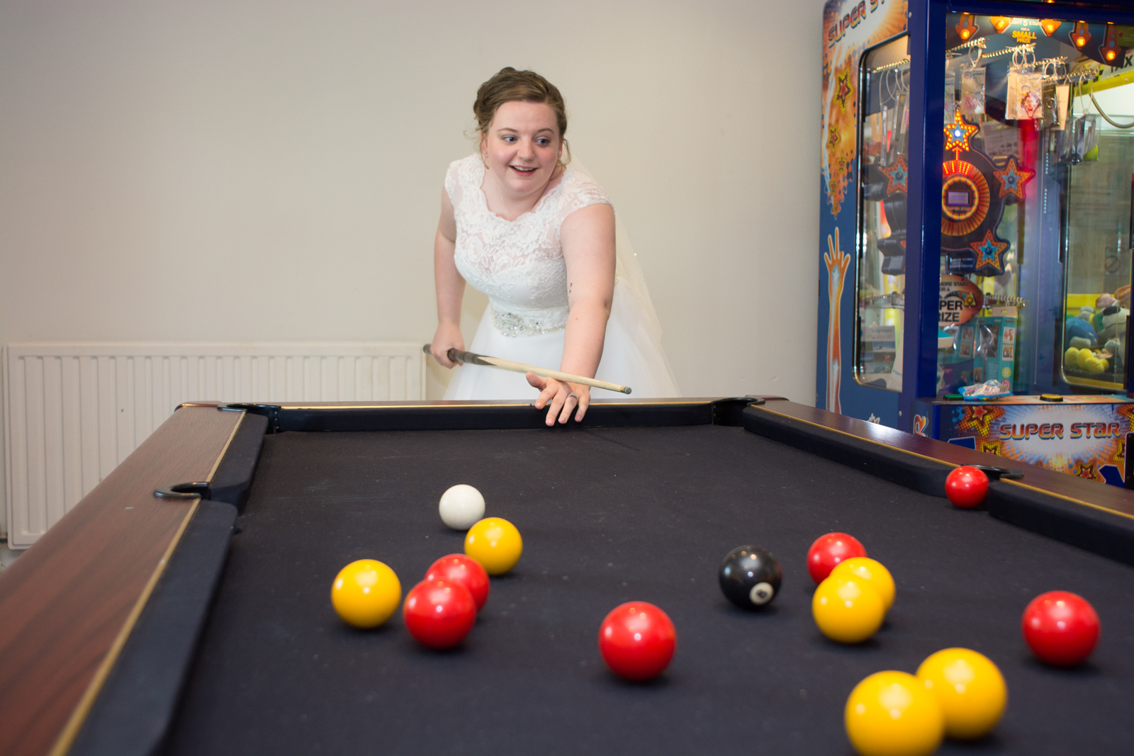 playing pool in her wedding dress at waterside cornwall
