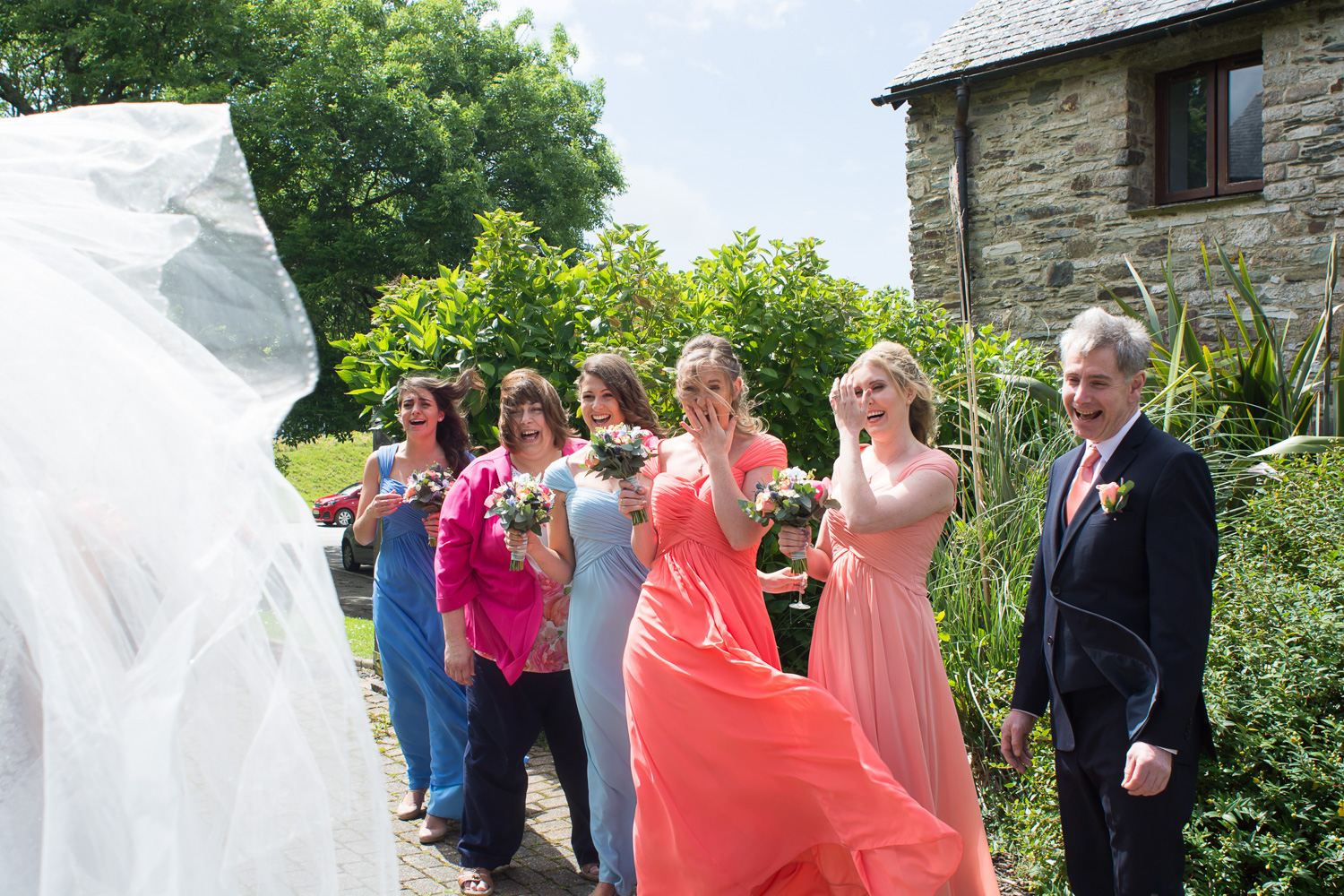 family reaction to the bride in her dress outside at boringdon hall