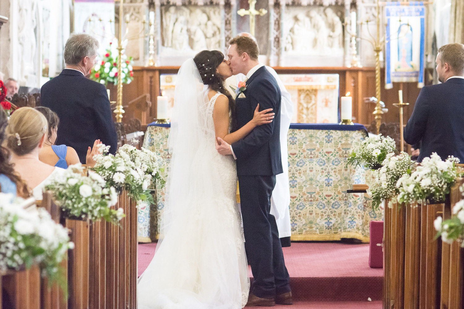 the bride and grooms first kiss at st mary's church plympton plymouth